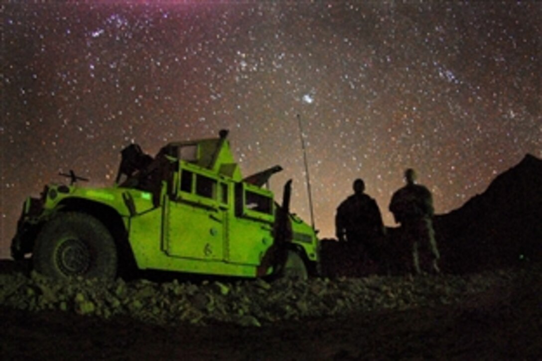 U.S. Army Spc. Stephen Highberger, left, and Pvt. Charles Joiner sit in a patrol base on an overnight mission near Forward Operation Base Lane in Zabul province, Afghanistan, March 13, 2009. Highberger and Joiner are assigned to Company B, 1st Battalion, 4th Infantry Regiment.