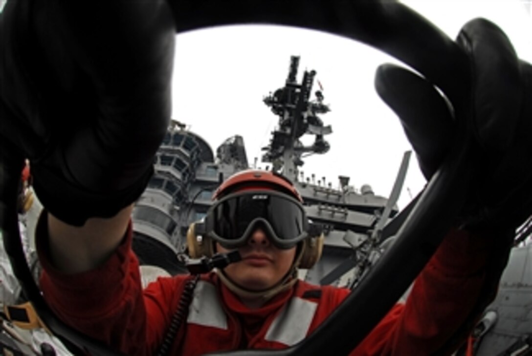 U.S. Navy Airman Arnold Quiroz mans a P-25 firefighting truck before flight operations on the flight deck aboard the aircraft carrier USS John C. Stennis (CVN 74) in the Pacific Ocean on March 7, 2009.  The Stennis is on a six-month deployment to the western Pacific.  