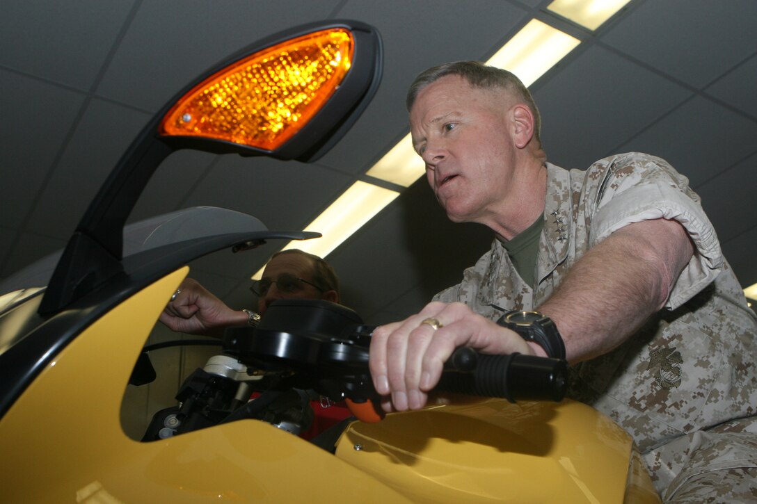 General James F. Amos, the assistant commandant of the Marine Corps takes 3rd Marine Aircraft Wing's new::r::::n::motorcycle simulator for a spin at Marine Corps Air Station Miramar, March::r::::n::16. The simulator will soon be used for the basic and advanced motorcycle::r::::n::rider course at the air station.