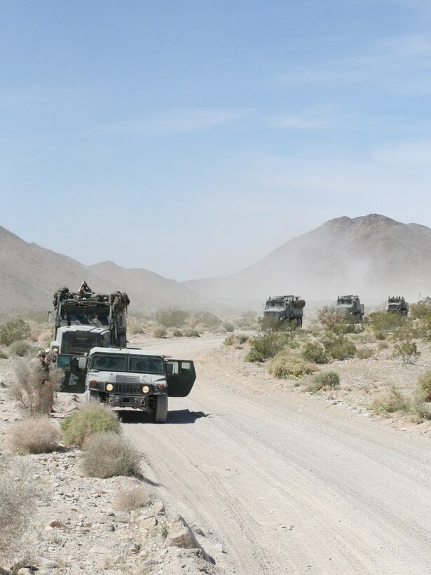 The convoy of 18 vehicles pulled to the side of the road to allow Light Armored Vehicles by before continuing the mission of dropping of the Marines, sailors and supplies of 1st Battalion, 5th Marine Regiment at Lead Mountain, a training area aboard the Combat Center, March 17.