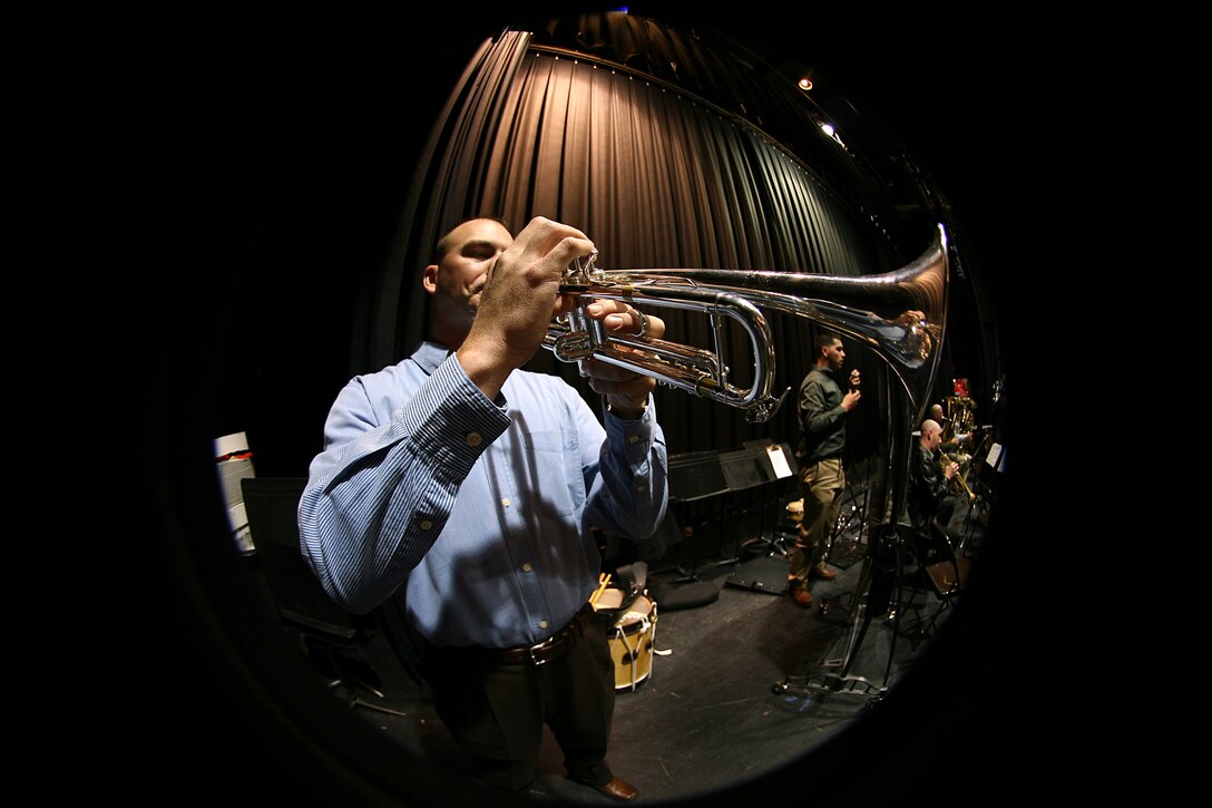 Cpl. Bryan King, a trumpet player with the 2nd Marine Aircraft Wing Band, warms up backstage before an evening show at Malverne High School in Malverne, N.Y., March 16. ::r::::n::