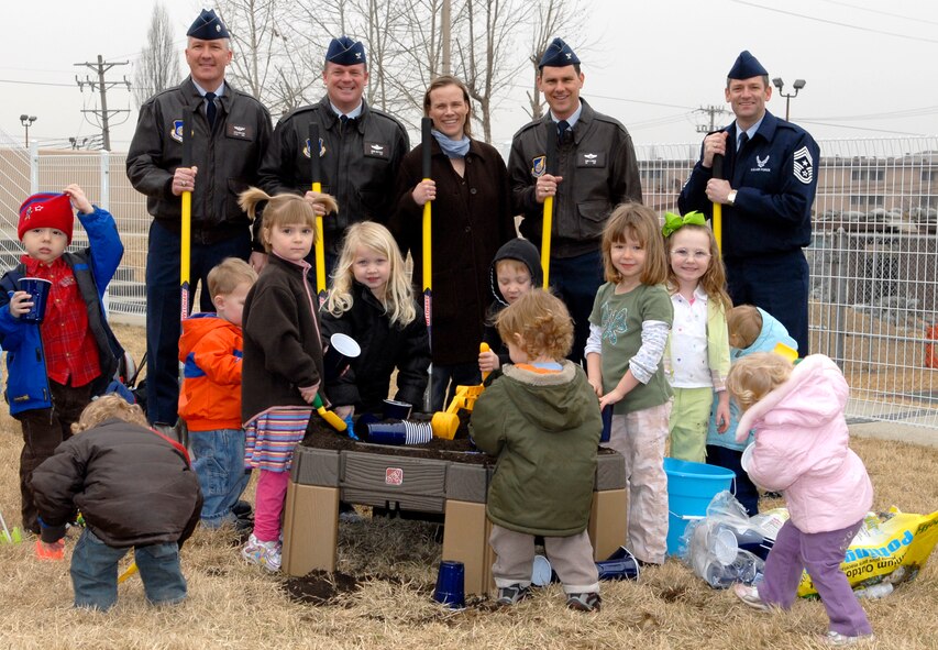 Osan Air Base children ages five and under and senior leadership break ground at the new Osan Community Garden, March 16.  The money for the project came from a Newman?s Own Award submitted by Anna Daggett that granted Osan $5,000.  The garden will be yet another tool to enhance children?s education and to provide nature and sustainable living projects for Osan children. (U.S. Air Force photo/Staff Sgt. Brian Ferguson)
