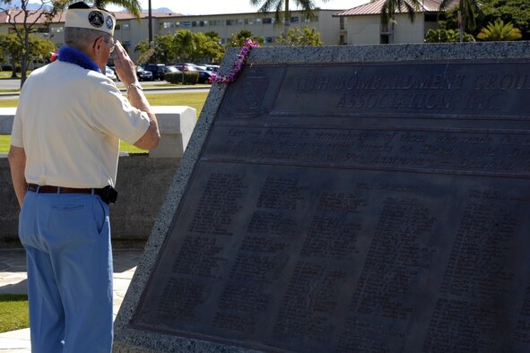 Henry Heim salutes his fallen friends from the 31st Bombardment Squadron, memorialized on a plaque near the base flag pole at Atterbury Circle. The memorial, donated by the 11th Bombardment Group, carries a Roll of Honor listing every person killed in action at Hickam Field, Hawaii, Dec. 7, 1941. More than 60 years after the attack, Mr. Heim returned to Hickam Air Force Base, Hawaii, March 13 to bid farewell to his fallen comrades.(U.S. Air Force photo/Chris Aguinaldo) 