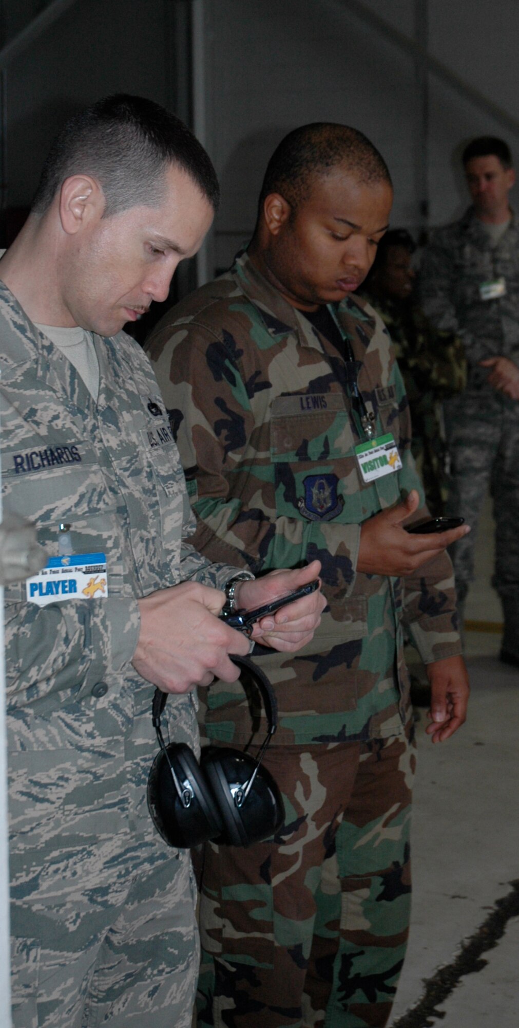 Airman 1st Class Eukenya Lewis and Tech. Sgt. Edgar Richards, both from the 38th Aerial Port Squadron, keep time while their teammates complete the joint inspection event at the 22nd Air Force Aerial Port ROUNDUP 2009 at Dobbins Air Reserve Base in Atlanta March 15. (U.S. Air Force photo/Capt. Bryan Lewis) 
