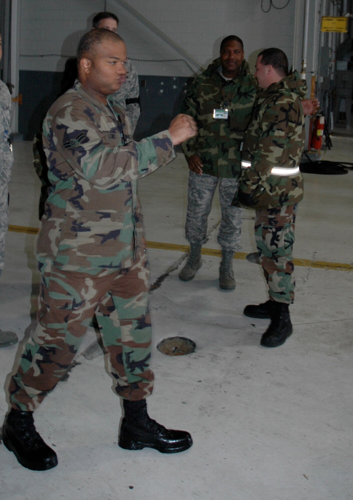 Airman 1st Class Eukenya Lewis, 38th Aerial Port Squadron, heads towards his fellow ROUNDUP teammates to congratulate them after an event during the 22nd Air Force Aerial Port ROUNDUP 2009 at Dobbins Air Reserve Base in Atlanta March 15. He, a Citadel cadet, was an alternate on the team who gave up his off weekends in order to compete. (U.S. Air Force photo/Capt. Bryan Lewis) 
