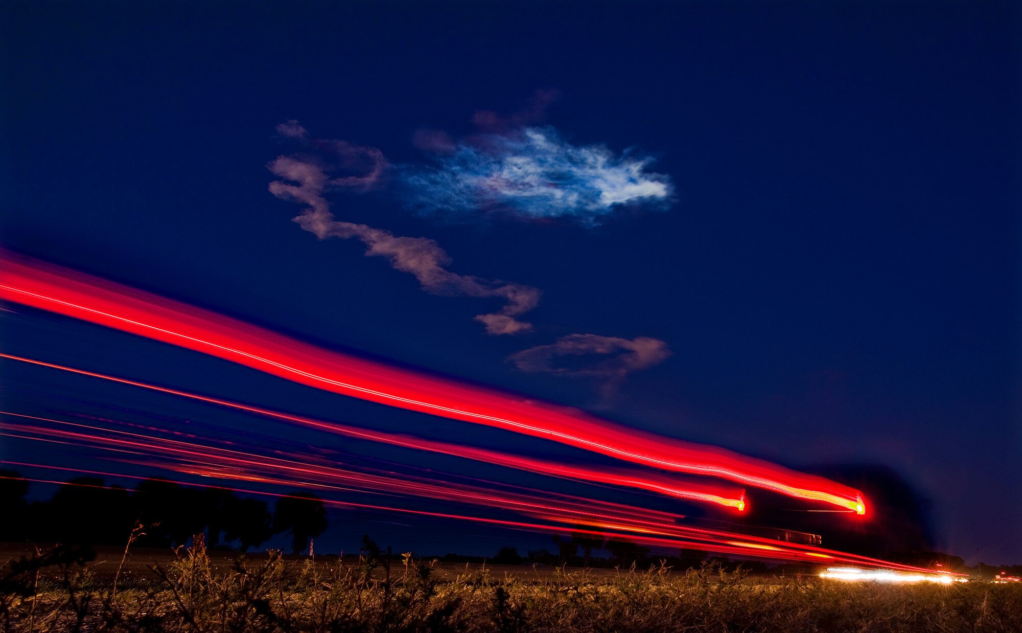 Traffic comes to a halt to watch space shuttle Mission STS-119 climb into space leaving contrails glowing in the night sky, March 16, Cape Canaveral, Fla.
(U.S. Air Force photo by/Staff Sgt. Bennie J. Davis III)