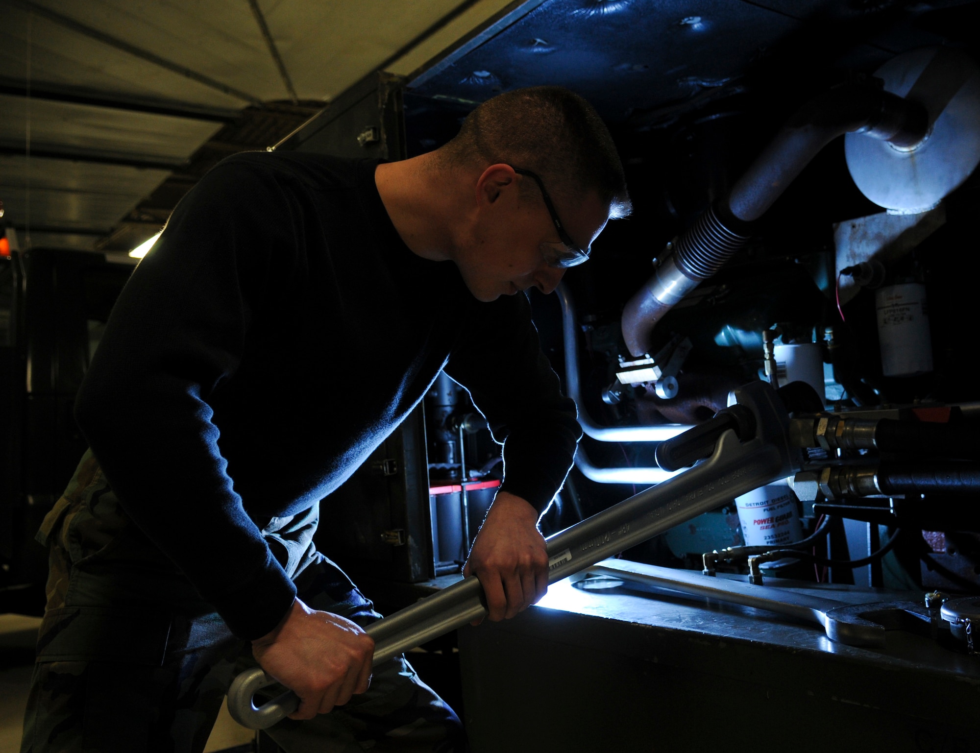 Senior Airman Michael Walsh, 354th Aerospace Ground Equipment apprentice, tightens a hydraulic hard-line March 17, 2009, Eielson Air Force Base, Alaska.  The hydraulic test stand provides regulated pressurized hydraulic fluid to aircraft. (U.S. Air Force photo/ Airman 1st Class Laura Max)