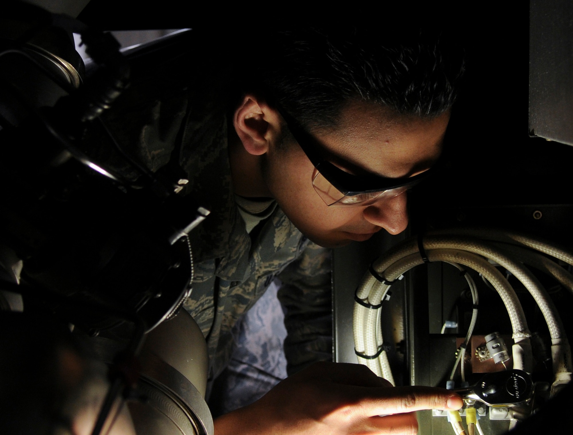 Airman 1st Class Sayed Lutfi, 354th Aerospace Ground Equipment apprentice, checks wiring inside an A/ M32A-60A gas turbine March 17, 2009, Eielson Air Force Base, Alaska. The turbine provides 115 volts of power to the aircraft while on the runway. (U.S. Air Force photo/ Airman 1st Class Laura Max)