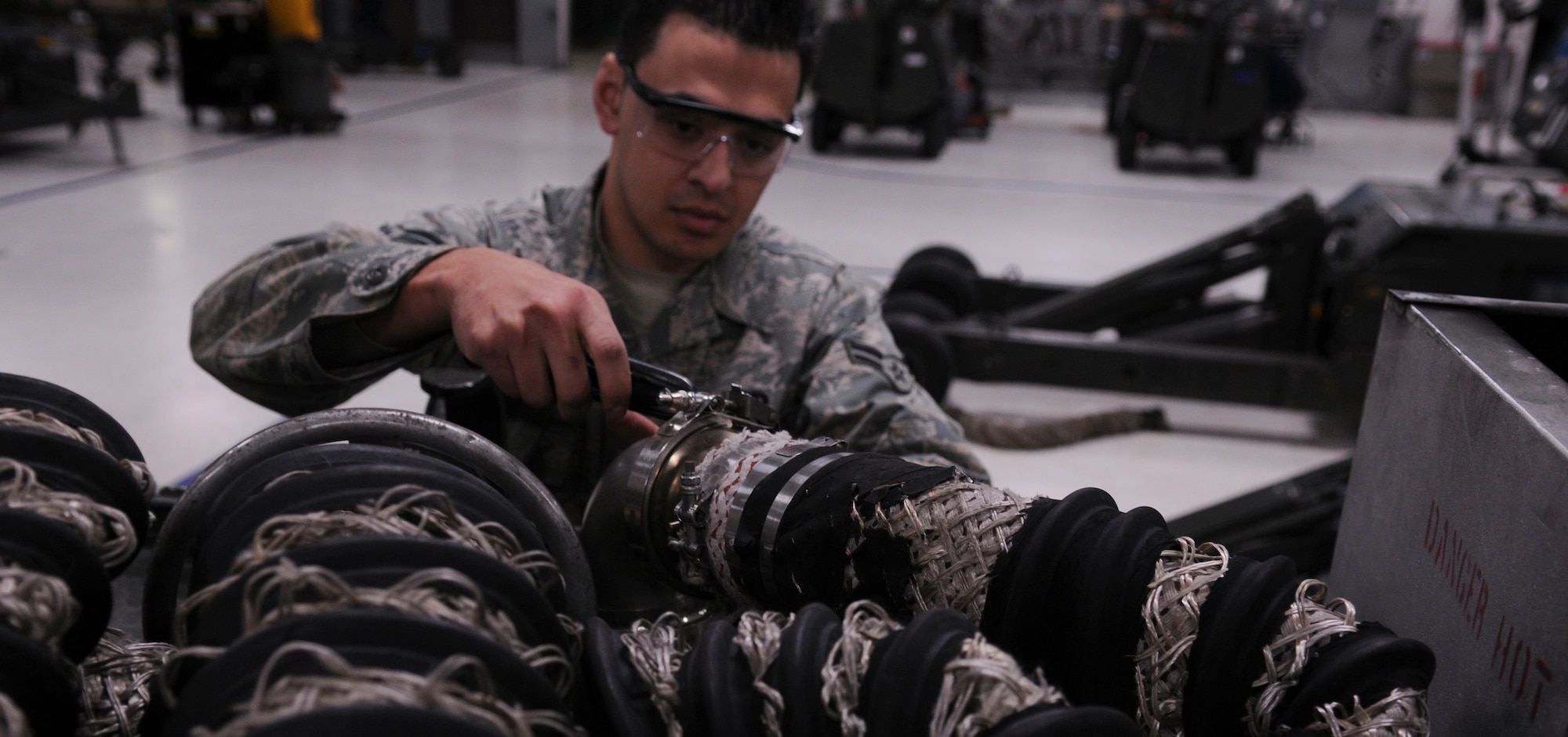 Airman 1st Class Sayed Lutfi, 354th Aerospace Ground Equipment apprentice, tightens a hose on an A/M32A-60A gas turbine March 17, 2009, Eielson Air Force Base, Alaska. The hoses are used to bleed high volume, low pressure air to aircraft. (U.S. Air Force photo/ Airman 1st Class Laura Max)