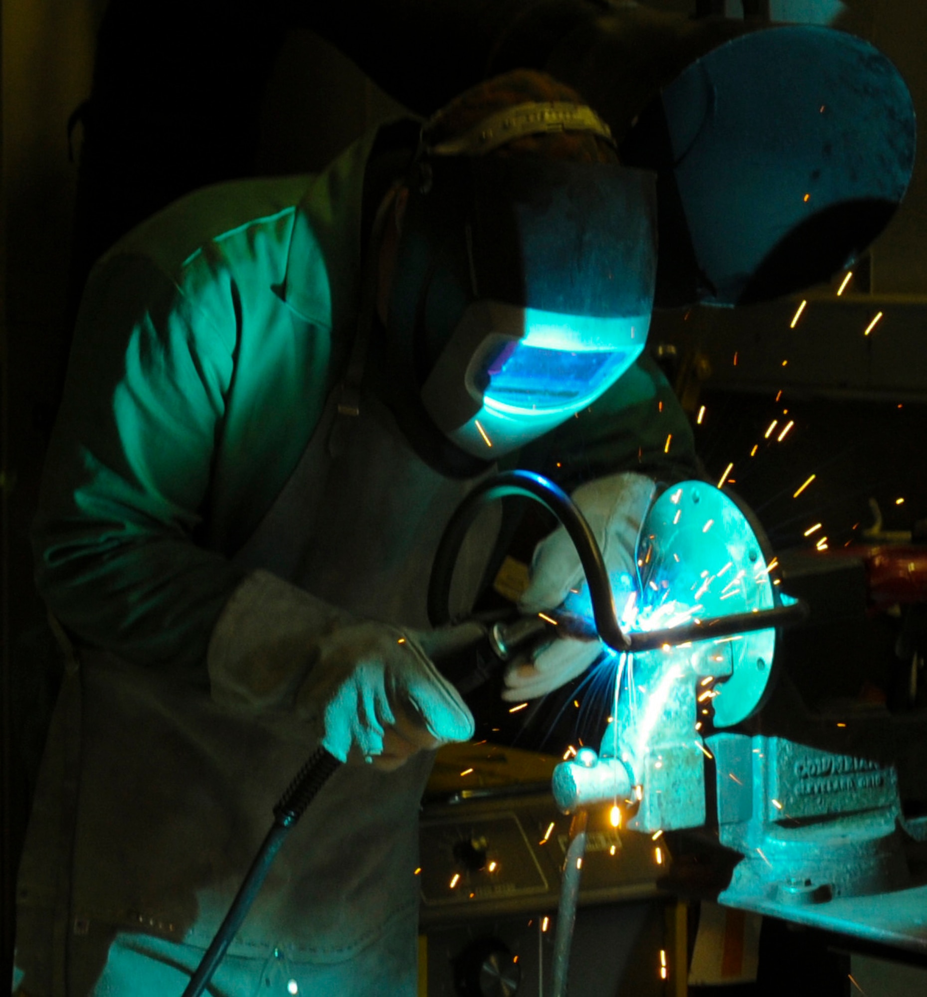 Marc  Thompson, 354th Aerospace Ground Equipment mechanic and welder, welds an MD-1 tow bar handle March 17, 2009, Eielson Air Force Base, Alaska.  Mr. Thompson uses the proper protective equipment to ensure his safety from the extreme heat of the arc. (U.S. Air Force photo/ Airman 1st Class Laura Max)