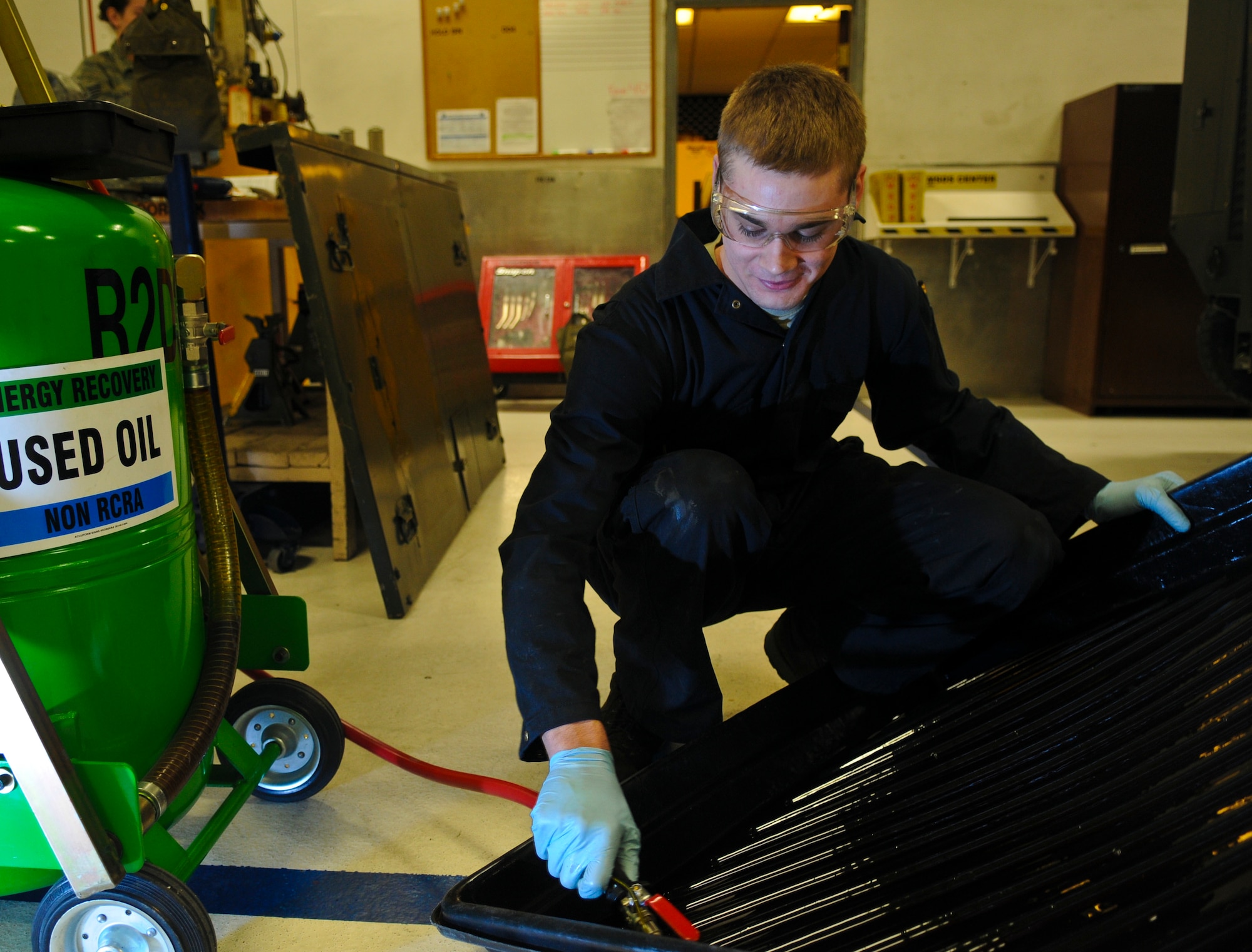 Airman 1st Class Michael Durgin, 354th Aerospace Ground Equipment apprentice, recycles hydraulic fluid March 17, 2009, Eielson Air Force Base, Alaska. The machine absorbs used oil and hydraulic fluid so it can be recycled and reused in the fleet. (U.S. Air Force photo/ Airman 1st Class Laura Max)