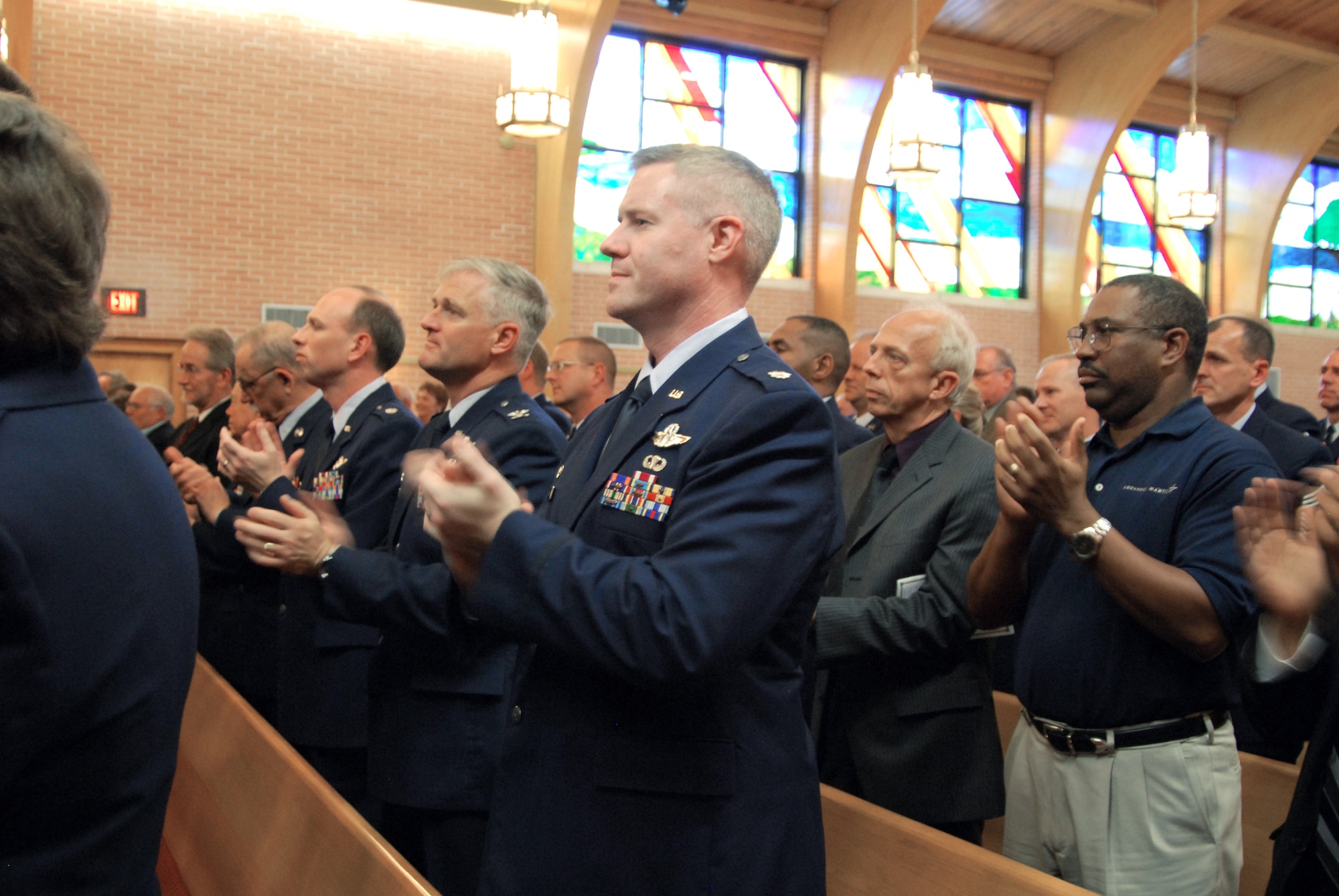Those in attendance at the March 16 memorial service for the first Chief Master Sgt. of the Air Force, Paul W. Airey, clap loudly, rejoicing the life of the Air Force legend. This was in response to a request by the eighth Chief Master Sgt. of the Air Force, Sam Parish, who said though those present were there to mourn, they should also celebrate the life of Paul W. Airey with "resounding applause." (U.S. Air Force photo/Lisa Norman) 
