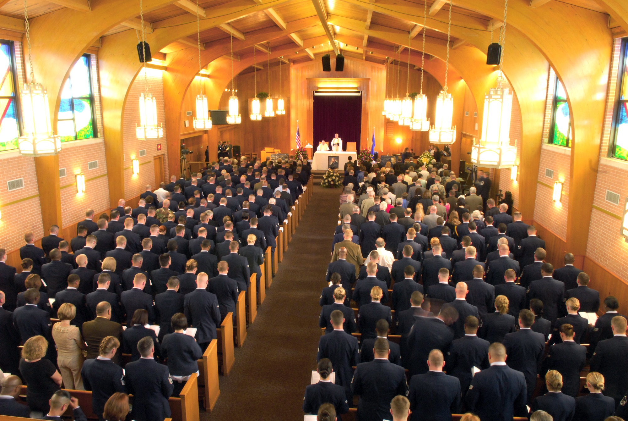 Members in attendance for the March 16 memorial service of the first Chief Master Sgt. of the Air Force, Paul W. Airey, bow their heads in silence as a prayer is delivered. Upon taking the podium to speak during the service, current Chief Master Sgt. of the Air Force Rodney McKinley said, "If Paul Airey could look through my eyes, he'd smile because all he could see is Air Force blue." (U.S. Air Force photo/Lisa Norman) 
