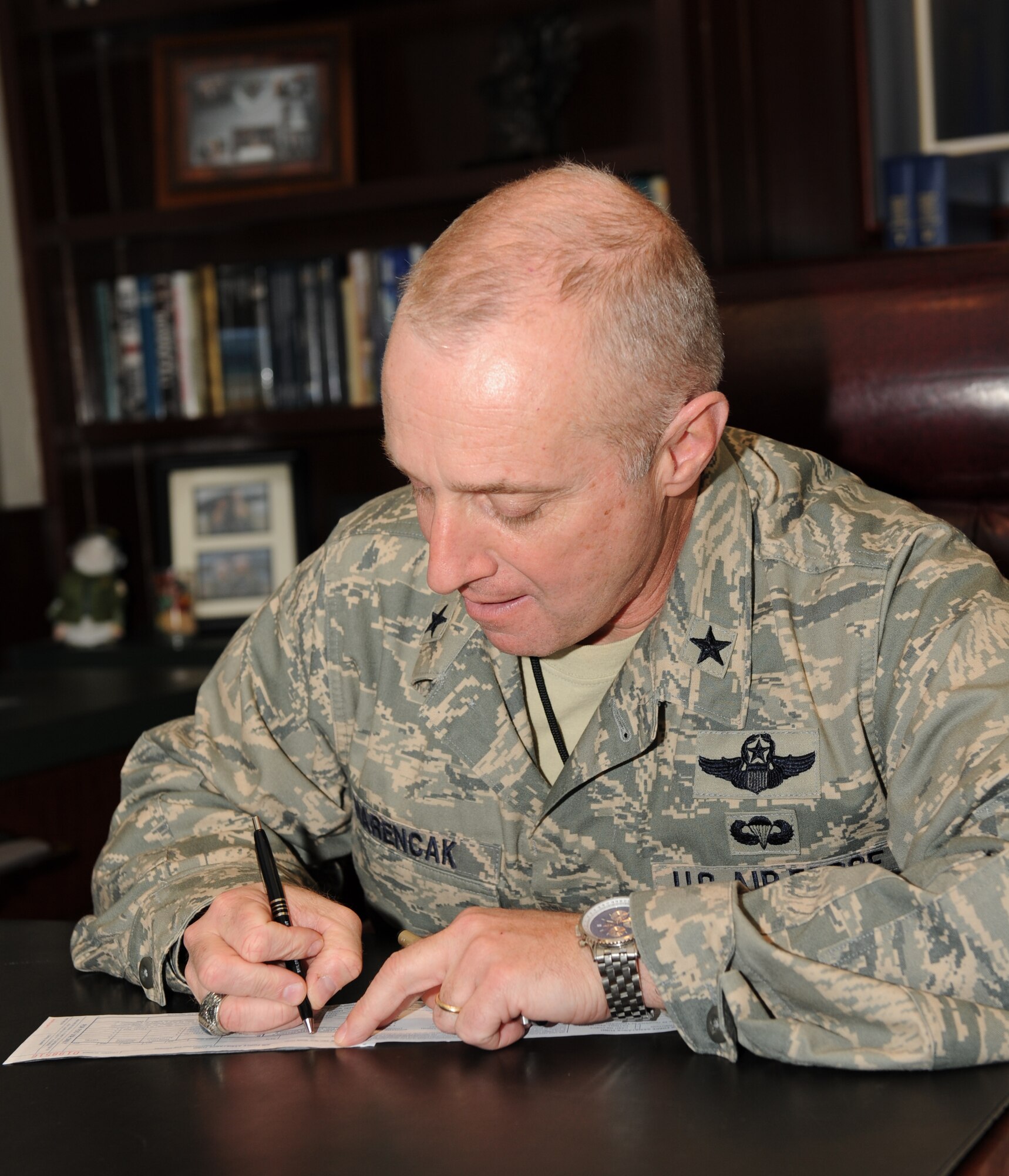 Brig. Gen. Garrett Harencak, 509th Bomb Wing commander, signs the first 2009 Air Force Assistance Fund form for Whiteman.  The AFAF is a campaign to raise money for the benefit of the Air Force and its extended community.  The represented charities are Air Force Aid Society, the General & Mrs. Curtis E. LeMay Foundation, the Air Force Village Indigent Foundation, Inc., and the Air Force Enlisted Village, Inc.  (U.S. Air Force photo/Senior Airman Jessica Snow)