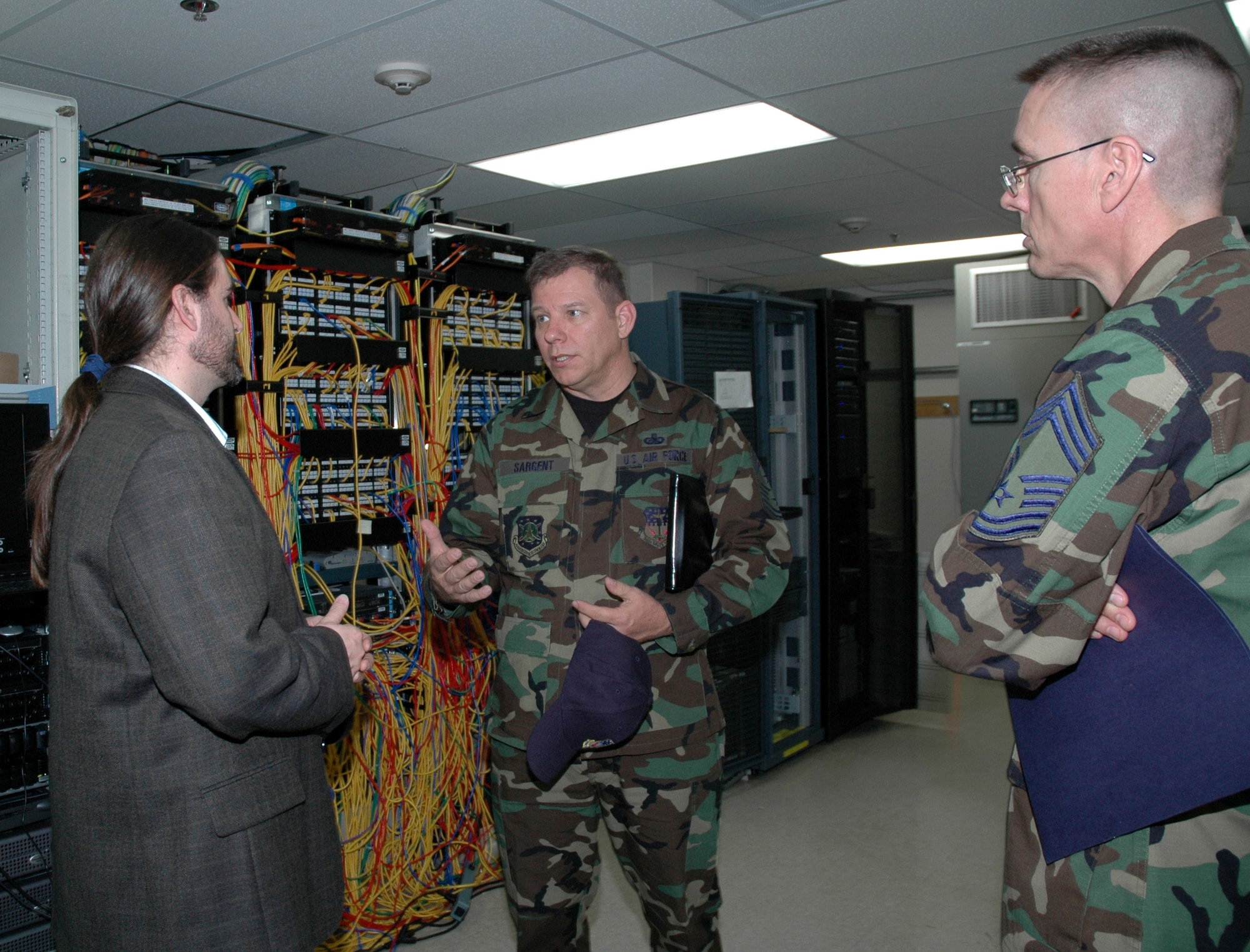 John Osment, chief information officer for the 341st Medical Group, briefs Chief Master Sgt. Steve Sargent, 341st Space Wing command chief master sergeant, on the communications capabilities at the Malmstrom Clinic while Chief Master Sgt. Richard Riddle, 341st MDG superintendent, looks on. Chief Sargent retired March 13, and served 30 years in the Air Force. (U.S. Air Force photo/Airman 1st Class Emerald Ralston)