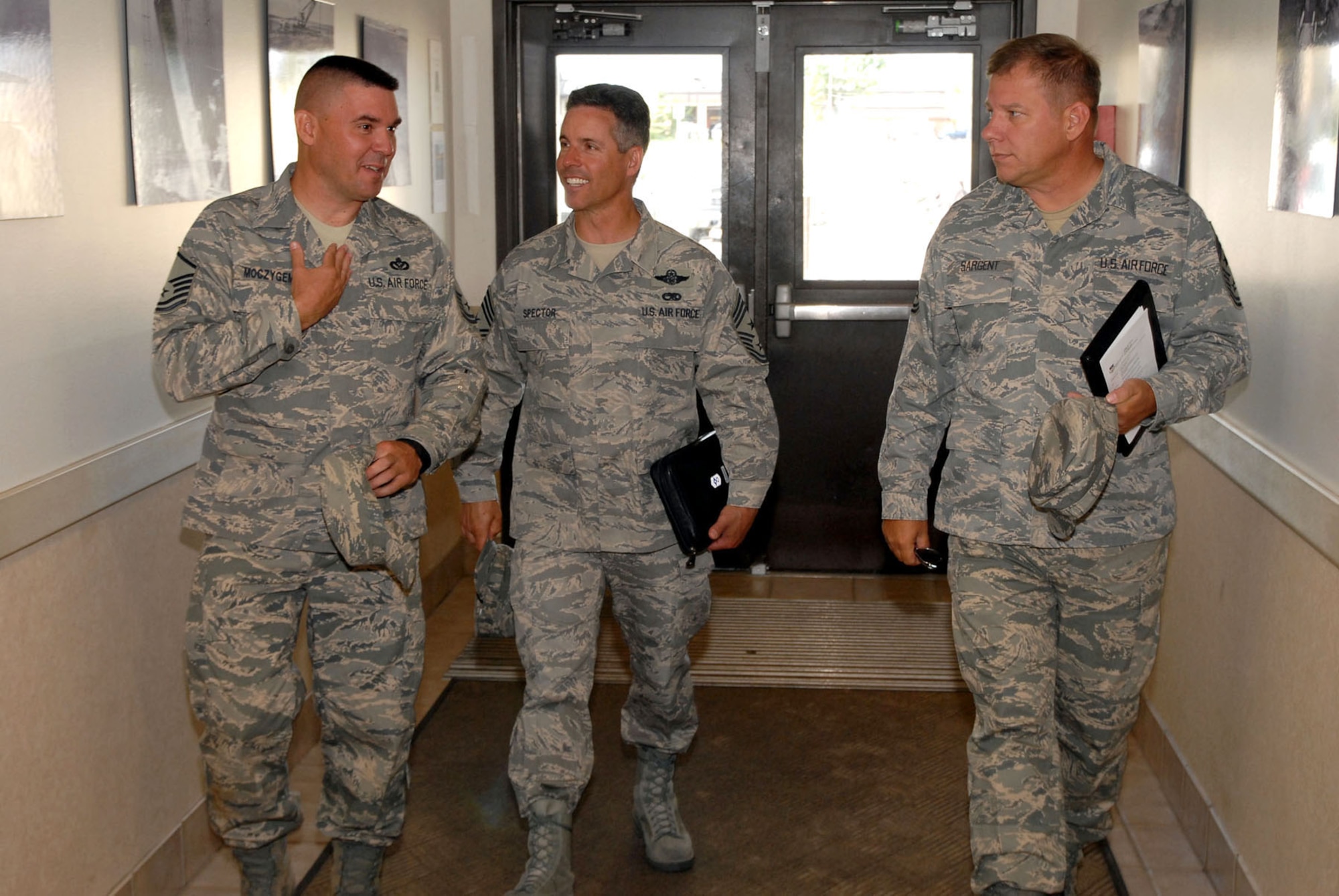Master Sgt. Albert Mocyygemba, Central Dorm Management Officer, escorts Chief Master Sgt. David Spector, 20th Air Force command chief (center) and Chief Master Sgt. Steve Sargent, 341st Missile Wing command chief, into dormitory 1082 prior to a tour of the facility Aug. 14.  Chief Spector was at Malmstrom again last week for Chief Sargent's retirement March 13. (U.S. Air Force photo/John Turner)