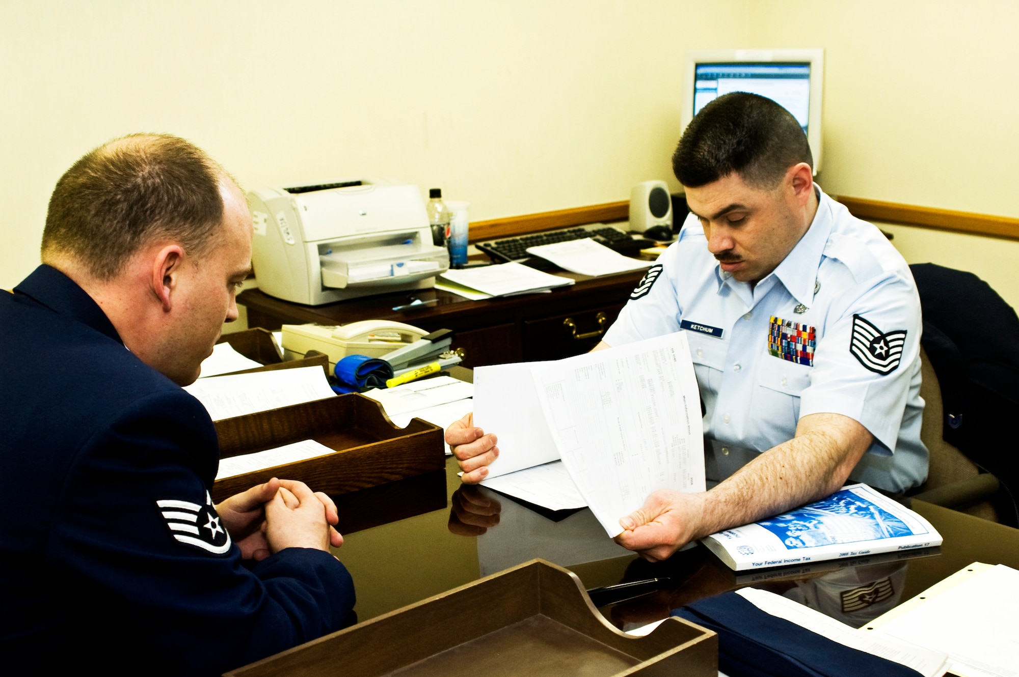 ELMENDORF AIR FORCE BASE, Alaska -- Tech. Sgt. Joel Ketchum, NCO in charge of the Elmendorf Tax Center, and Staff Sgt. Matthew Lordier, 3rd Equipment Maintenance Squadron, review Lordier's taxes. Lordier came to the Elmendorf Tax Center for the free services they offer. (U.S. Air Force photo/Airman Jack Sanders)