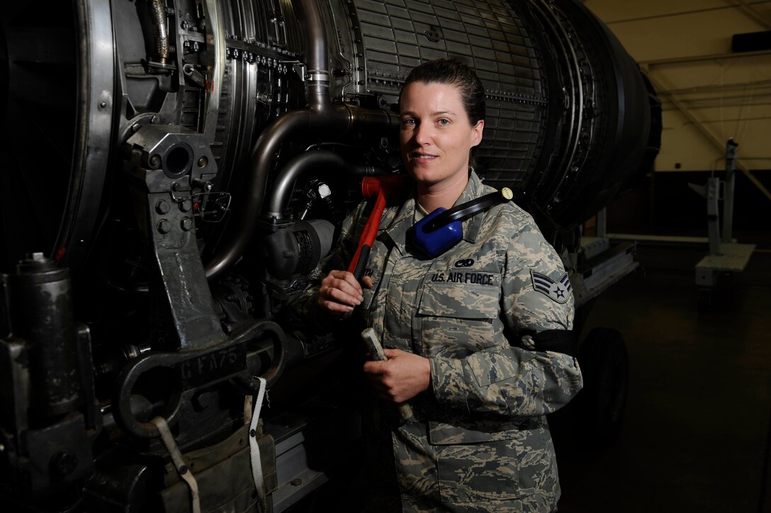 Senior Airman Deanna Neuharth, 28th Maintenance Squadron aerial space propulsion lead technician, holds a rubber mallet and drift in front of a General Electric F101 turbofan engine here, March 17. Airman Neuharth is one of three women working in the propulsion backshop. Since 1987, the month of March has been recognized as Women's History Month and highlights women of the past and future. (US Air Force photo/Airman 1st Class Corey Hook)