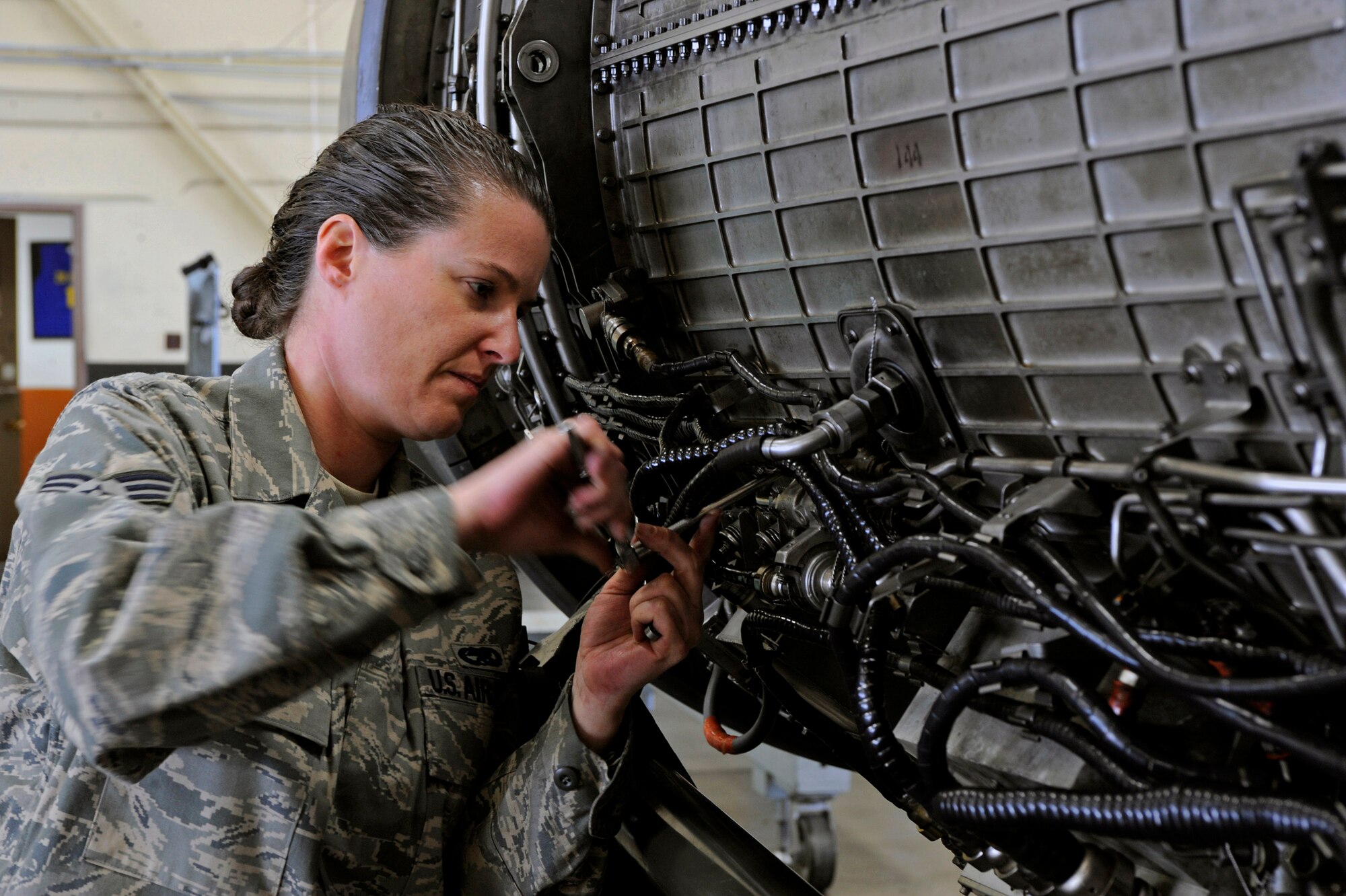 Senior Airman Deanna Neuharth, 28th Maintenance Squadron aerial space propulsion lead technician, performs a final inspection on a B-1B Lancer General Electric F101 turbofan engine here, March 17.  Airmen Neuharth made last minute adjustments before a quality assurance team performed an inspection ensuring engine safety.(U.S. Air Force photo/Airman 1st Class Matthew Flynn)
