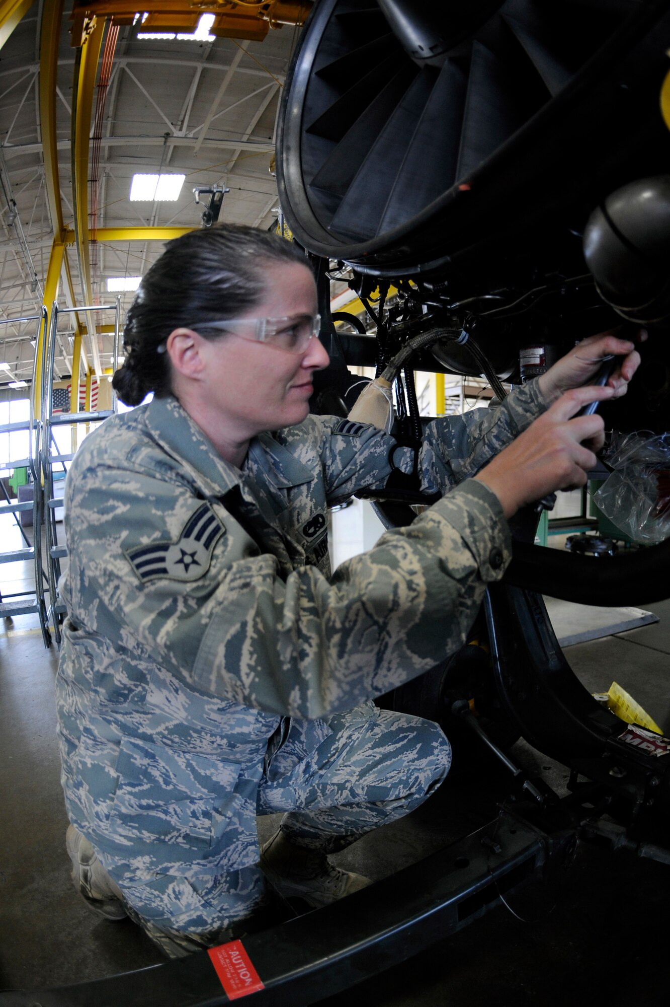 Senior Airman Deanna Neuharth, 28th Maintenance Squadron aerial space propulsion technician, makes final adjustments to a B-1B Lancer General Electric F101 turbofan engine here, March 17.  Airman Neuharth is one of three women working in the propulsion backshop. Since 1987, the month of March has been recognized as Women's History Month and highlights women of the past and future. (U.S. Air Force photo/Airman 1st Class Matthew Flynn)