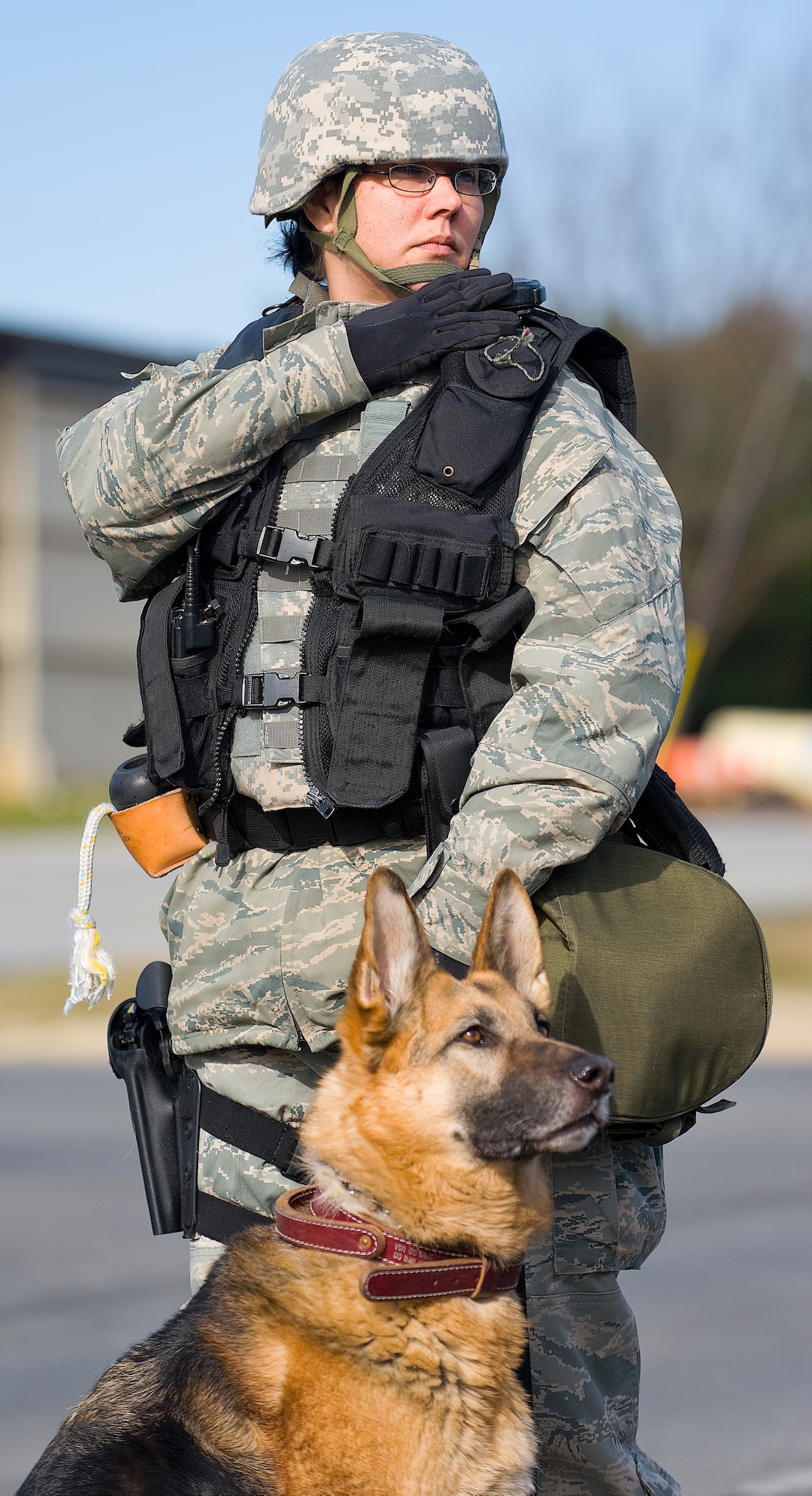 Senior Airman Gina Castro, 436th Security Forces Squadron military working dog handler, responds to a call during the Major Accident Response Exercise March 12 with 9-year-old German Sheppard, Stoney. (U.S. Air Force photo/Roland Balik)