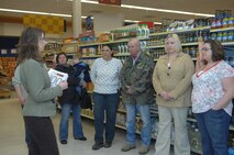 MINOT AIR FORCE BASE, N.D. -- Michelle Fundingsland, 5th Force Support Squadron Health and Wellness Center dietitian, guides a group of Minot locals through the base Commissary to show a variety of healthy foods that are provided March 13.  Members from Trinity Hospital and the HAWC provided the tour to educate both the base and community on dieting tips and to promote healthy eating habits. (U.S. Air Force photo by Airman 1st Class Jesse Lopez)