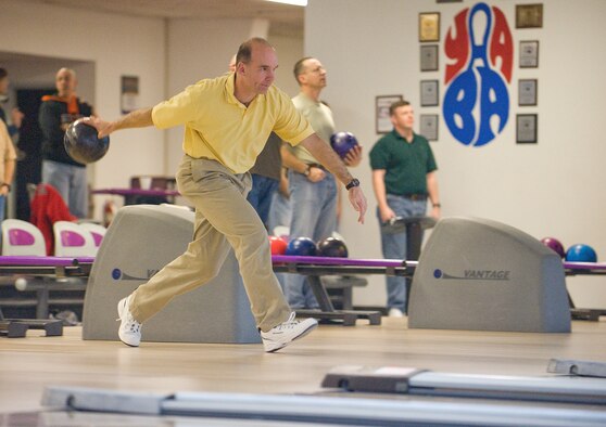 Col. Manson Morris, 436th Airlift Wing commander, rolls out the first strike in the Chiefs vs. Eagles bowling tournament.  The Chiefs defeated the Eagles 1285 to 1087.  (U.S. Air Force Photo/Tom Randle)