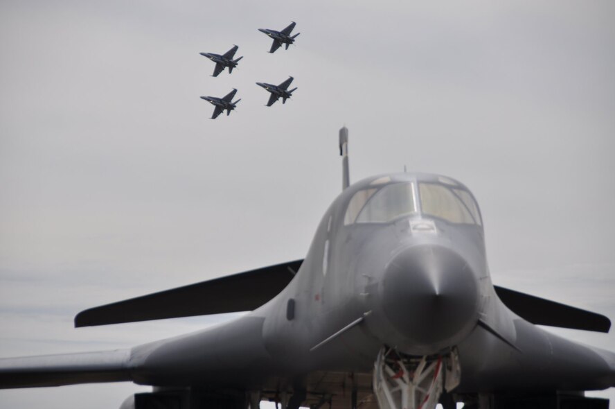 AVALON AIRPORT, Victoria, Australia –A B1-B Lancer sits on display while four Royal Australian Air Force F/A-18s practice for an upcoming performance at the 2009 Australian International Airshow March 12. The B-1B Lancer is from the 37th Bomber Squadron, Ellsworth Air Force Base, S.D. (U.S.  Air Force photo/Tech Sgt. Cohen A. Young) 