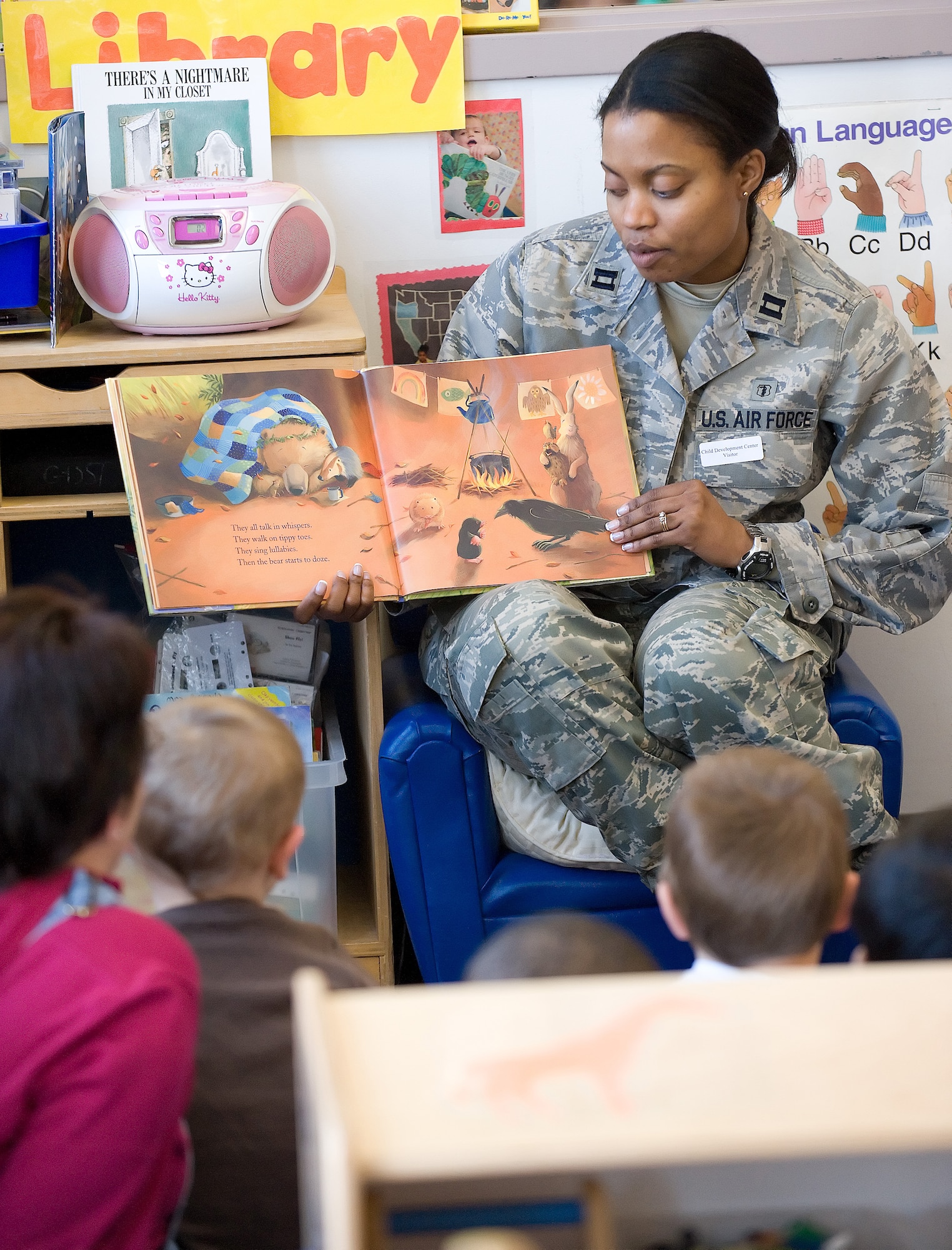 Capt. Trinette Flowers-Torres, 436th Aerospace Medicine Squadron, reads "Bear feels sick" to children at the Child Development Center.  The book teaches children the proper way to stop the spread of germs.  (U.S. Air Force Photo/Jason Minto)