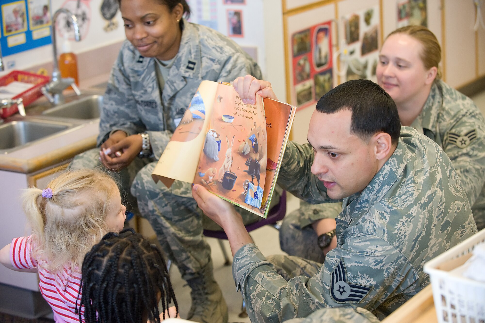 Staff Sgt. Pedro Pena, 436th Aerospace Medicine Squadron, reads the book ?Bear feels sick? to children at the Child Development Center.  The book teaches children how to prevent the spread of germs.  (U.S. Air Force Photo/Jason Minto)
