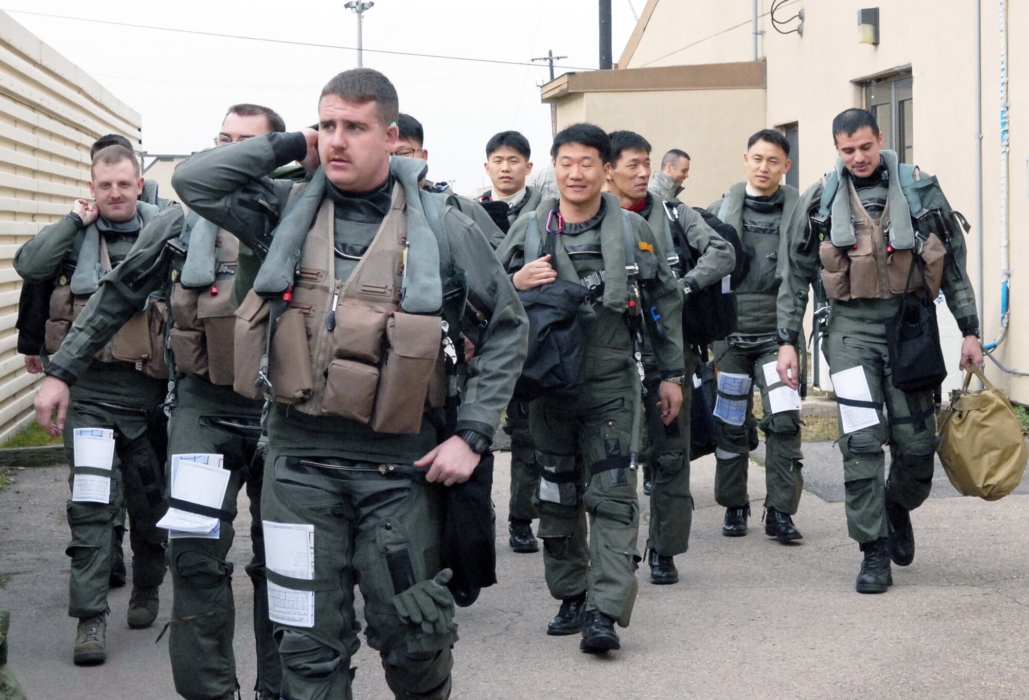 South Korean and American Airmen step to their jets in preparation for takeoff during the Buddy Wing program March 11 at Kunsan Air Base, South Korea. The Buddy Wing program is designed to increase United States Air Force and South Korean air force interoperability.( U.S. Air Force photo/Senior Airman Dana Hill) 
