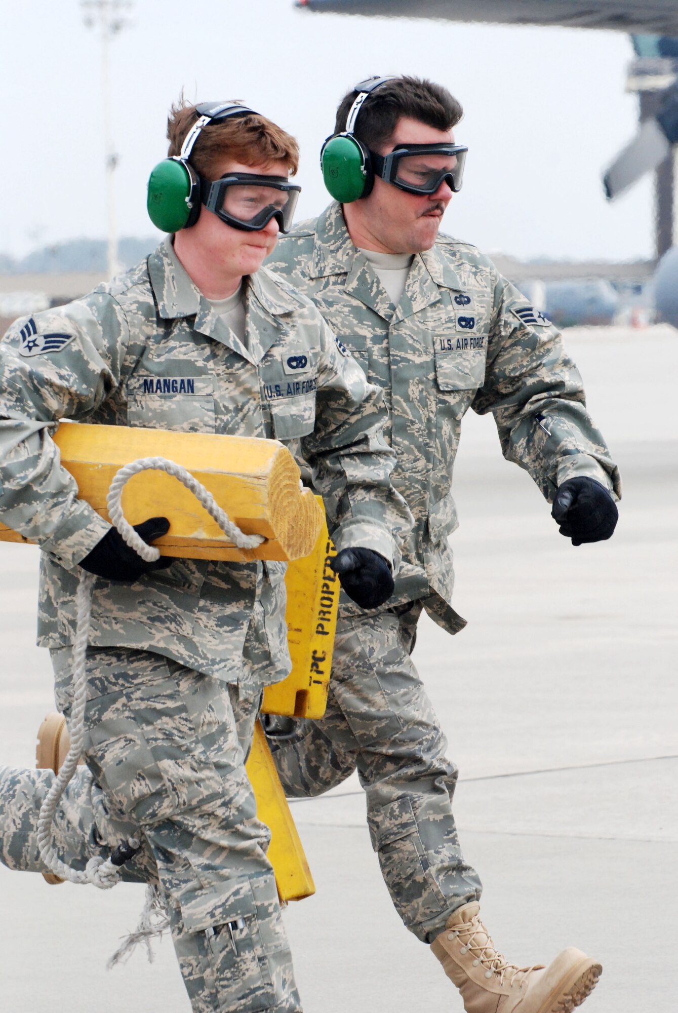 Senior Airmen Melanie Mangan, left, and Michael Boehm race to the engine running on/off load event at 22nd Air Force's Aerial Port Roundup at Dobbins Air Reserve Base, Ga., March 13, 2009. Both Airmen are reservists from the 32nd Aerial Port Squadron, Pittsburgh International Airport Air Reserve Station, Pa. (U.S. Air Force photo/Staff Sgt. Steve Lewis)