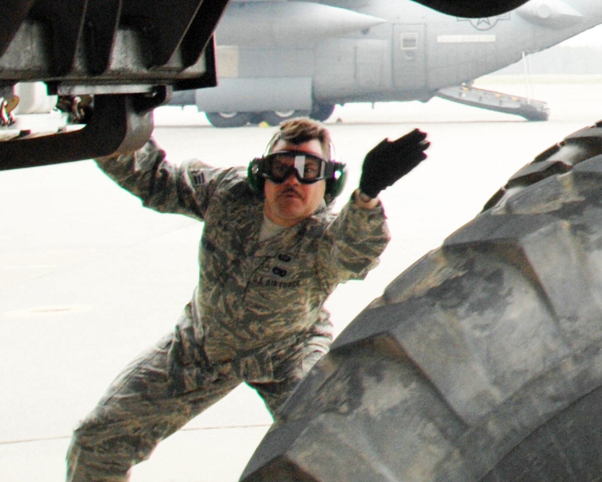 Senior Airman Michael Boehm, a member of the 32nd Aerial Port Squadron, guides a HUMVEE out of a C-130 aircraft in the engines running off/on load event during the 22nd Air Force?s Aerial Port Roundup at Dobbins Air Reserve Base, Ga., March 13-15, 2009. This was the first competition of its kind for the reservist from Pittsburgh International Airport Air Reserve Station, Pa. (U.S. Air Force photo/2nd Lt. J. Justin Pearce)