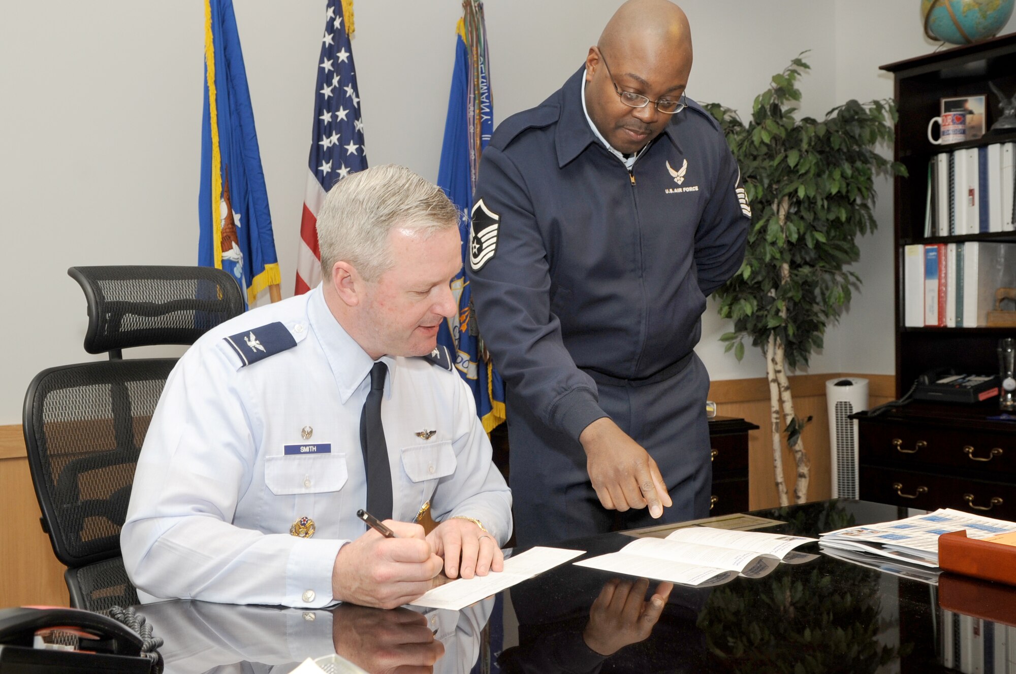 Col. Scott Smith, 305th Air Mobility Wing commander, fills out a donation form for the Air Force Assistance Fund March 16. Master Sgt. Corey Reid, 6th Airlift Squadron and base AFAF POC, assisted Colonel Smith with his donation. The campaign will continue through April 7. Contact your squadron POC to make a contribution. (U.S. Air Force photo/Carlos Cintron)
