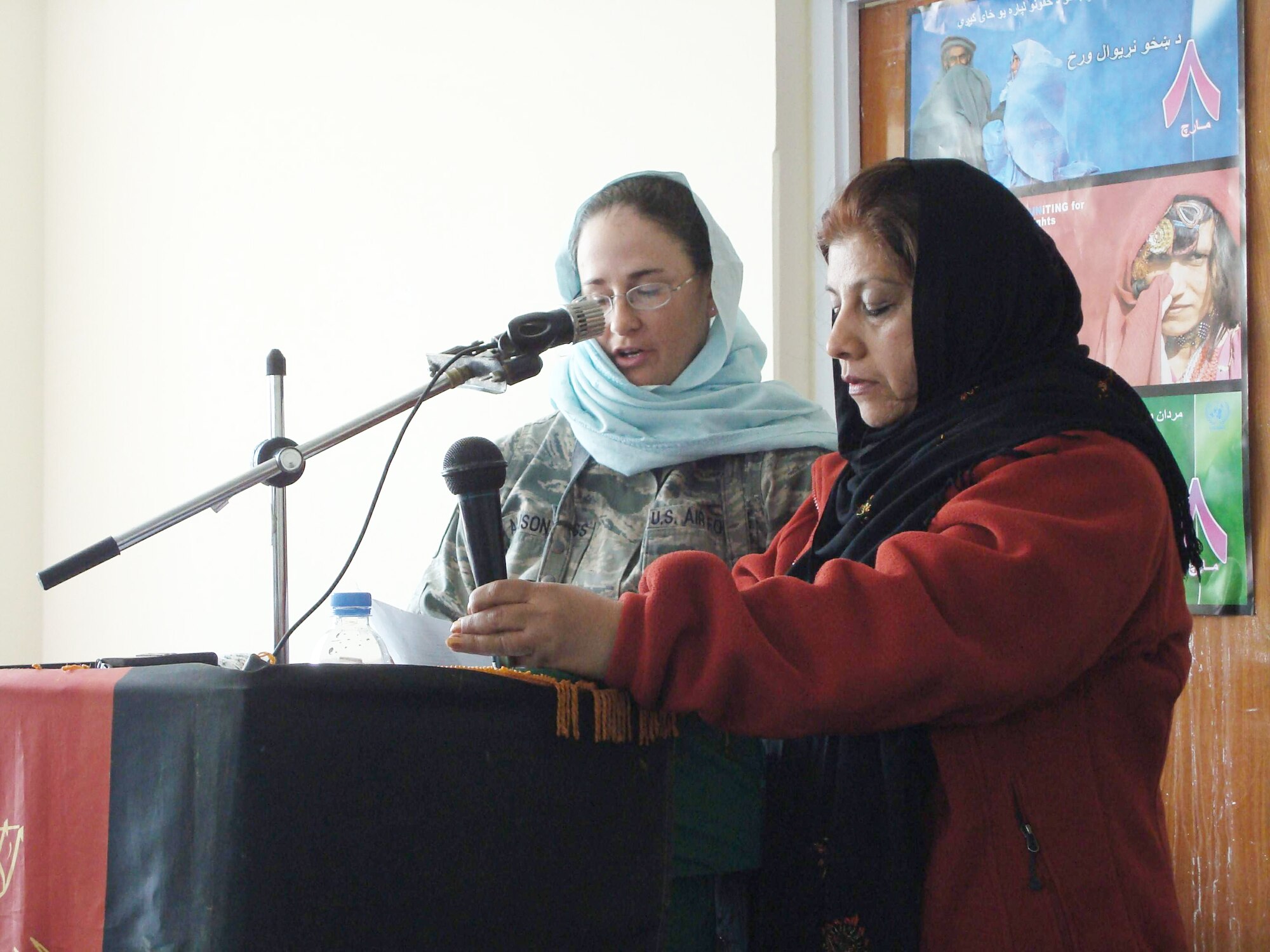 Tech. Sgt. Dawn Allison-Hess, accompanied by interpreter Jamila, speaks with nearly 125 women and girls from Panjshir Valley who attended the March 8 International Women's Day celebration in Bazarak District in Afghanistan. The audience heard from the province's deputy governor and a former female Afghan judge. Sergeant Allison-Hess is the Panjshir Provincial Reconstruction Team intelligence officer and is deployed from Goodfellow Air Force Base, Texas. (U.S. Air Force photo/Capt. Stacie N. Shafran) 
