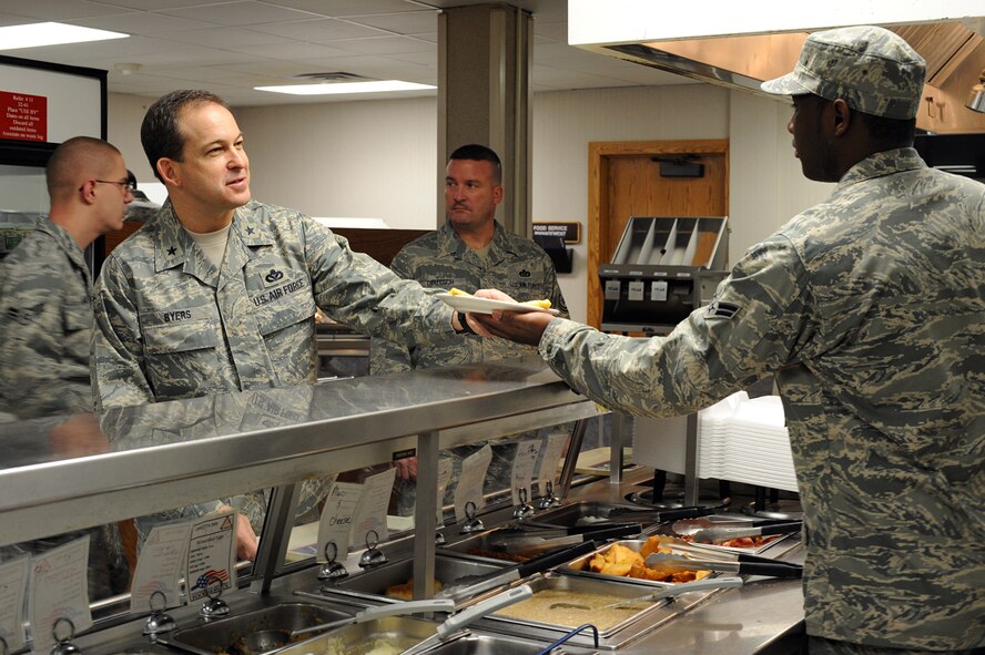 MINOT AIR FORCE BASE, N.D. – Airman 1st Class Travis Pettway, a cook with the 5th Force Support Squadron, hands breakfast to Brig. Gen. Timothy A. Byers, Director of Installations and Mission Support, Headquarters Air Combat Command, Langley AFB, Va., at the Dakota Dining Facility here March 17. General Byers visit to Minot AFB was to gain first-hand experience with the challenges of operating in Minot’s extreme winter environment.  (U.S. Air Force photo by Senior Airman Kelly Timney)