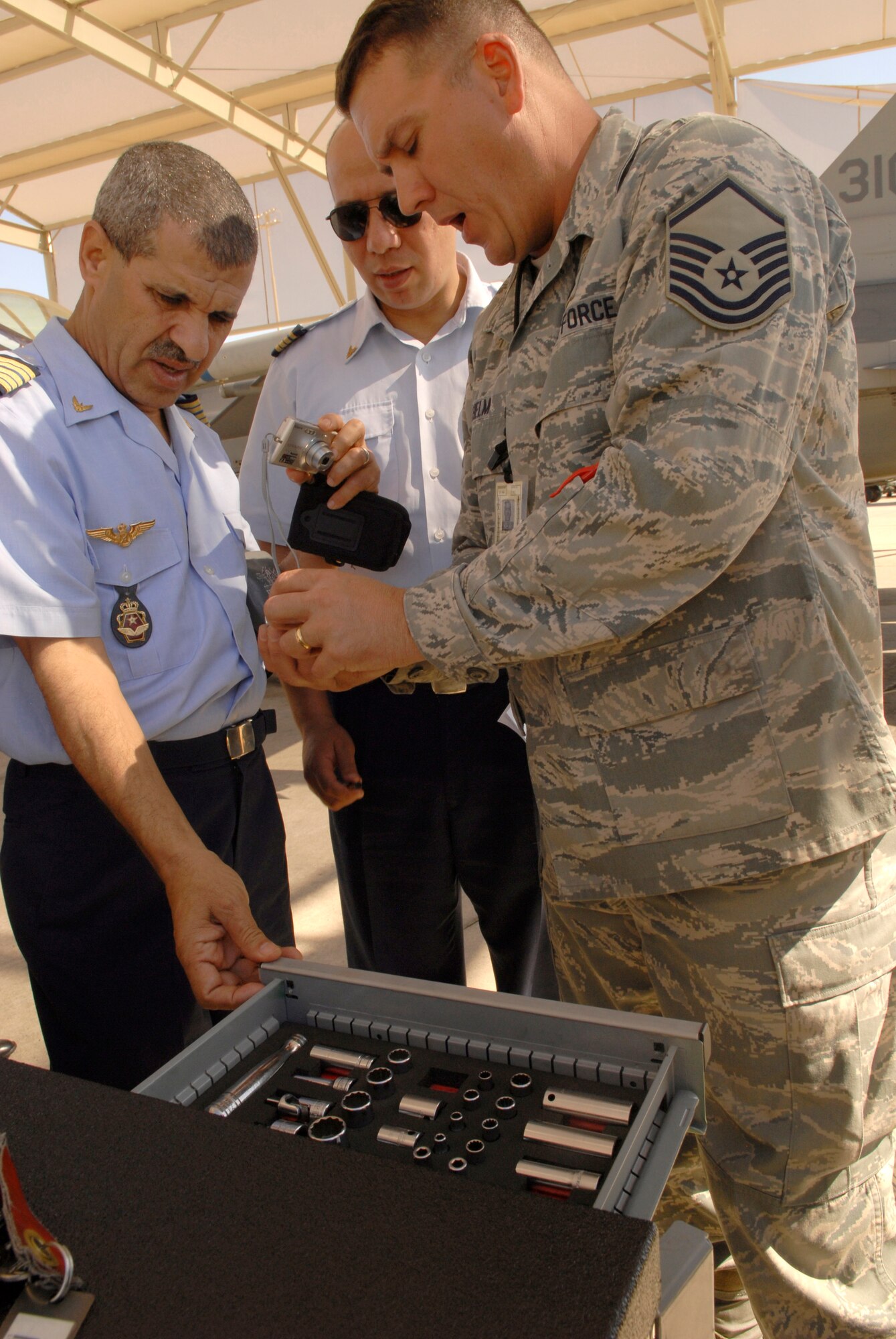 Master Sgt. Michael Helm, 310th Aircraft Maintenance Unit, describes features of a composite tool kit to members of the Royal Moroccan air force on March 12.  Members of the RMAF visited Luke Air Force Base, Ariz., to learn about Air Force maintenance procedures. (U.S. Air Force photo/ Staff Sgt. Ian Dean)