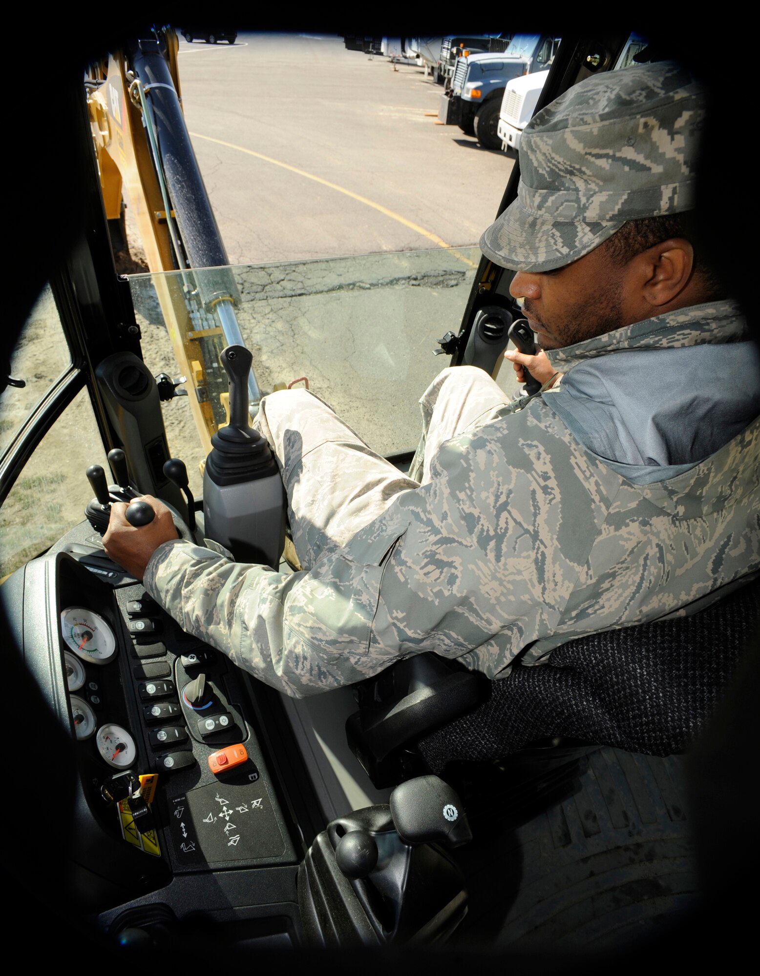 During a utility dig March 12, Senior Airman Phil McCain, 87th Civil Engineer Heavy Equipment Shop operator, revs up the RPM on a backhoe. Personnel from the 87th CES work on a variety of projects around McGuire, such as repairing all pot holes, maintenance and repair of perimeter fences, placing barricades during exercises, clearing all storm drains, cutting and clearing downed trees and branches after storms, and street sweeping. These “jacks-of-all-trades” Airmen are available 24 hours a day, seven days a week. (U.S. Air Force photo/Carlos Cintron)