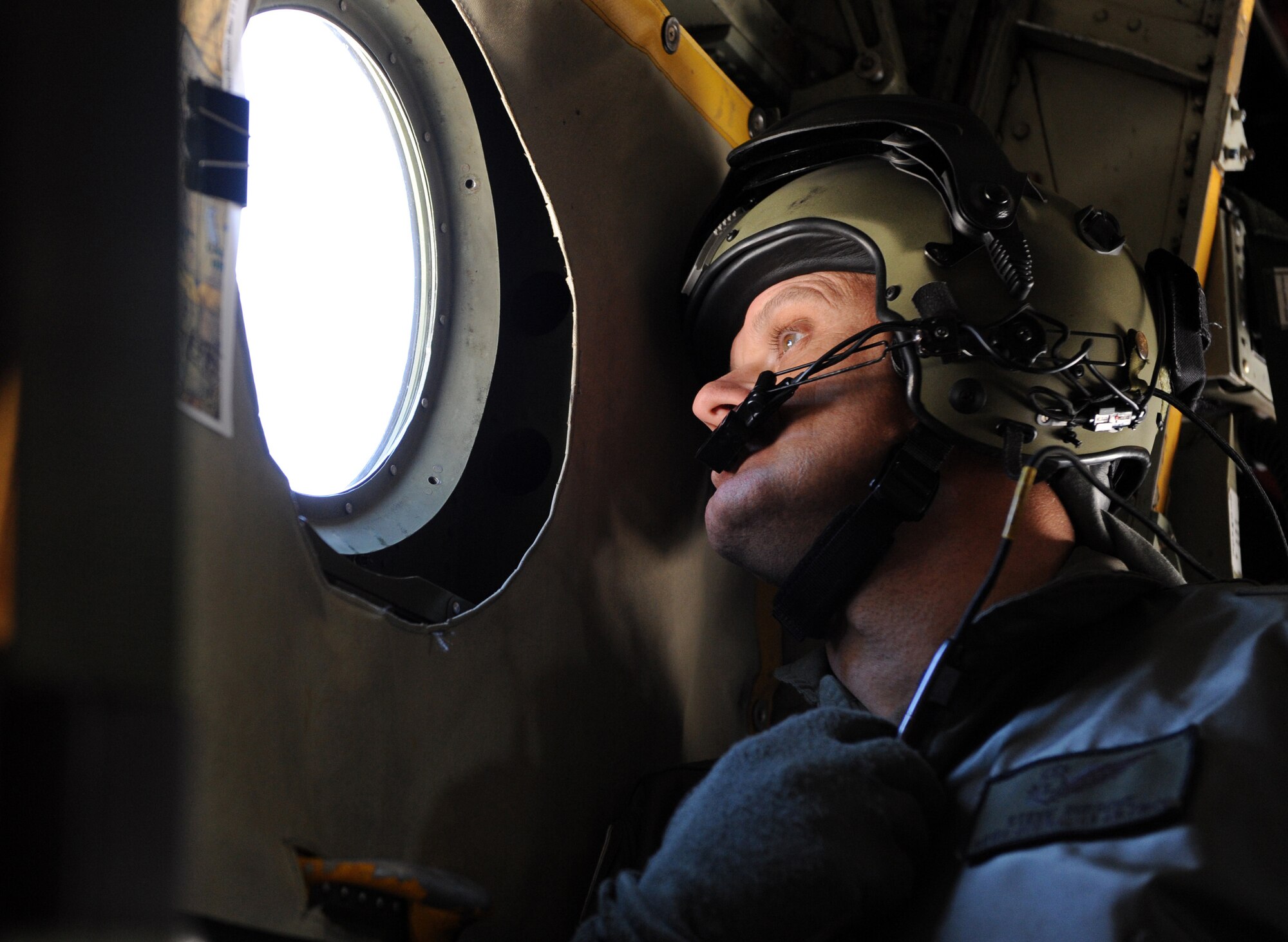 NELLIS AIR FORCE BASE, Nev., -- Warrant Officer Steven Burrows, Royal Australian Air Force 37th Squadron, looks out a window of a RAAF C-130 Hercules before a Survival, Evasion, Resistance and Escape, or SERE, static line jump during Red Flag 09-3 March 5. SERE specialists prepare aircrews and other high-risk personnel to survive under any conditions. Red Flag, which concluded March 13, featured more than 90 aircraft, 2,000 personnel and 27 units from the United States military and its allies. (U.S. Air Force photo by Airman 1st Class Debbie Lockhart)