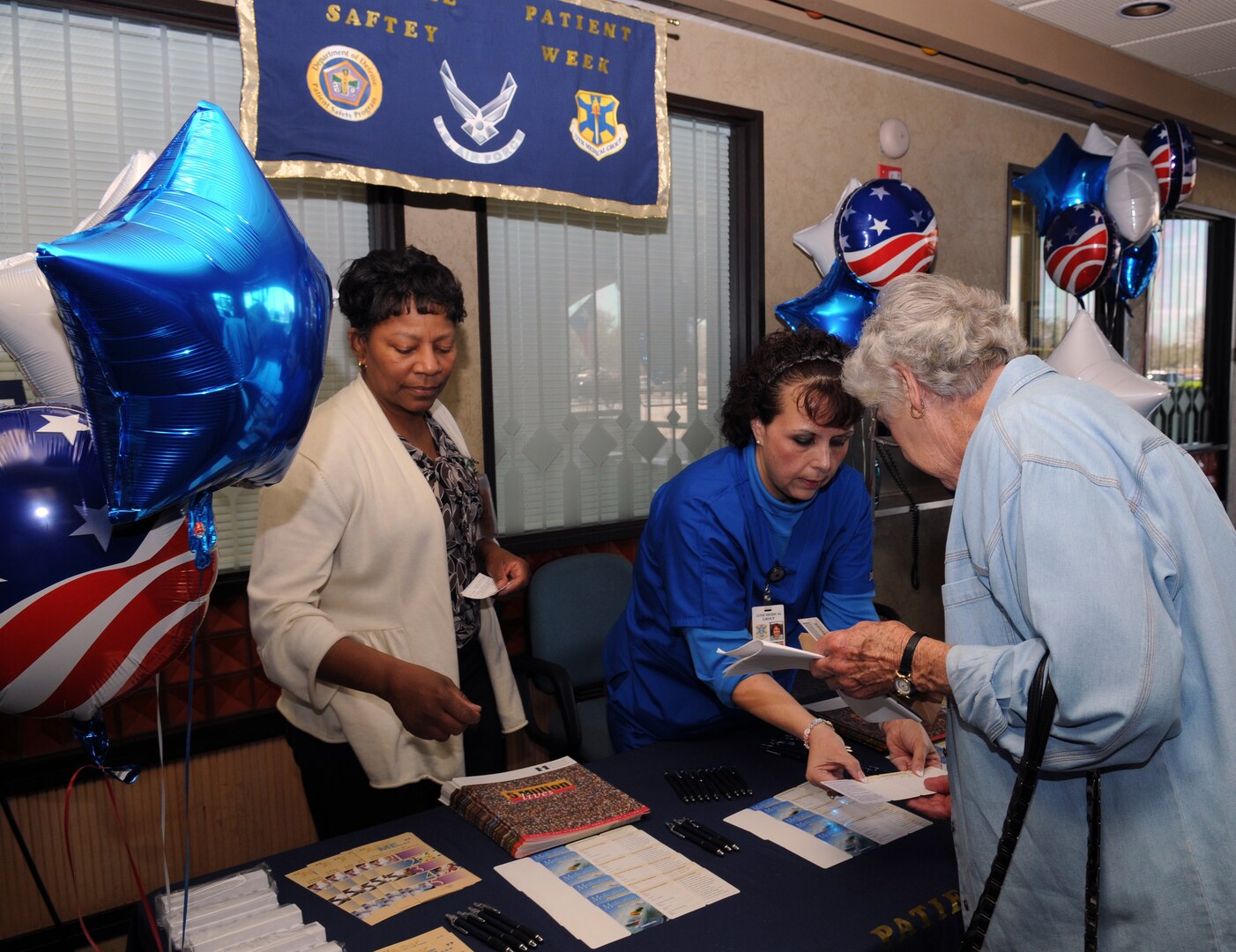 Alma Abalos and Drewann Encinas, 12th Medical Group, hand out information on health screenings and medical safety during National Patient Safety Week last week. (U.S. Air Force photo by Rich McFadden)