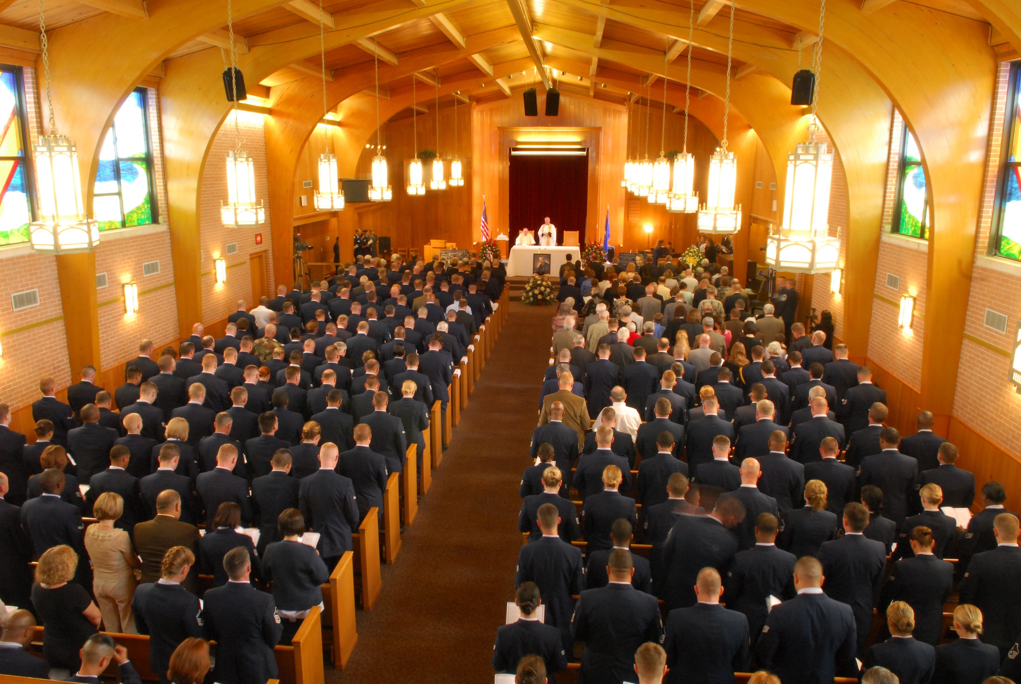 Members in attendance for the memorial service of the first Chief Master Sgt. of the Air Force, Paul W. Airey, bow their heads in silence as a prayer is delivered. Upon taking the podium to speak during the service, current Chief Master Sgt. of the Air Force Rodney McKinley said, "If Paul Airey could look through my eyes, he'd smile because all he could see is Air Force blue." (U.S. Air Force photo/Lisa Norman)
