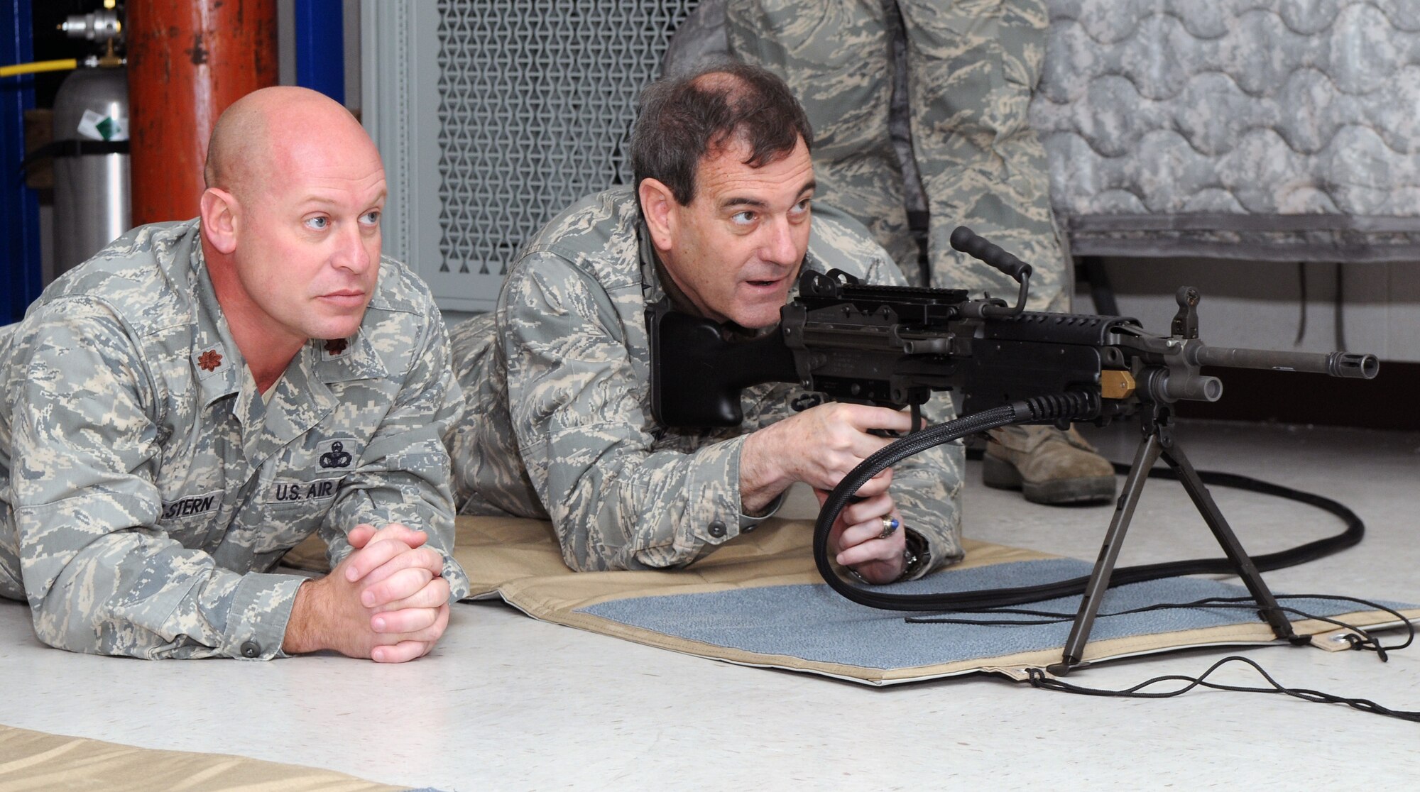 Gen. Stephen Lorenz, Air Education and Training Command commander, takes aim at the new FATS, or FireArms Training Simulator, system with instruction from Maj. Frank Hellstern, 12th Security Forces Squadron. General Lorenz visited the wing March 12-13 to learn about the mission and people who both work for and support the needs of the major command. (U.S. Air Force photo by Joel Martinez)