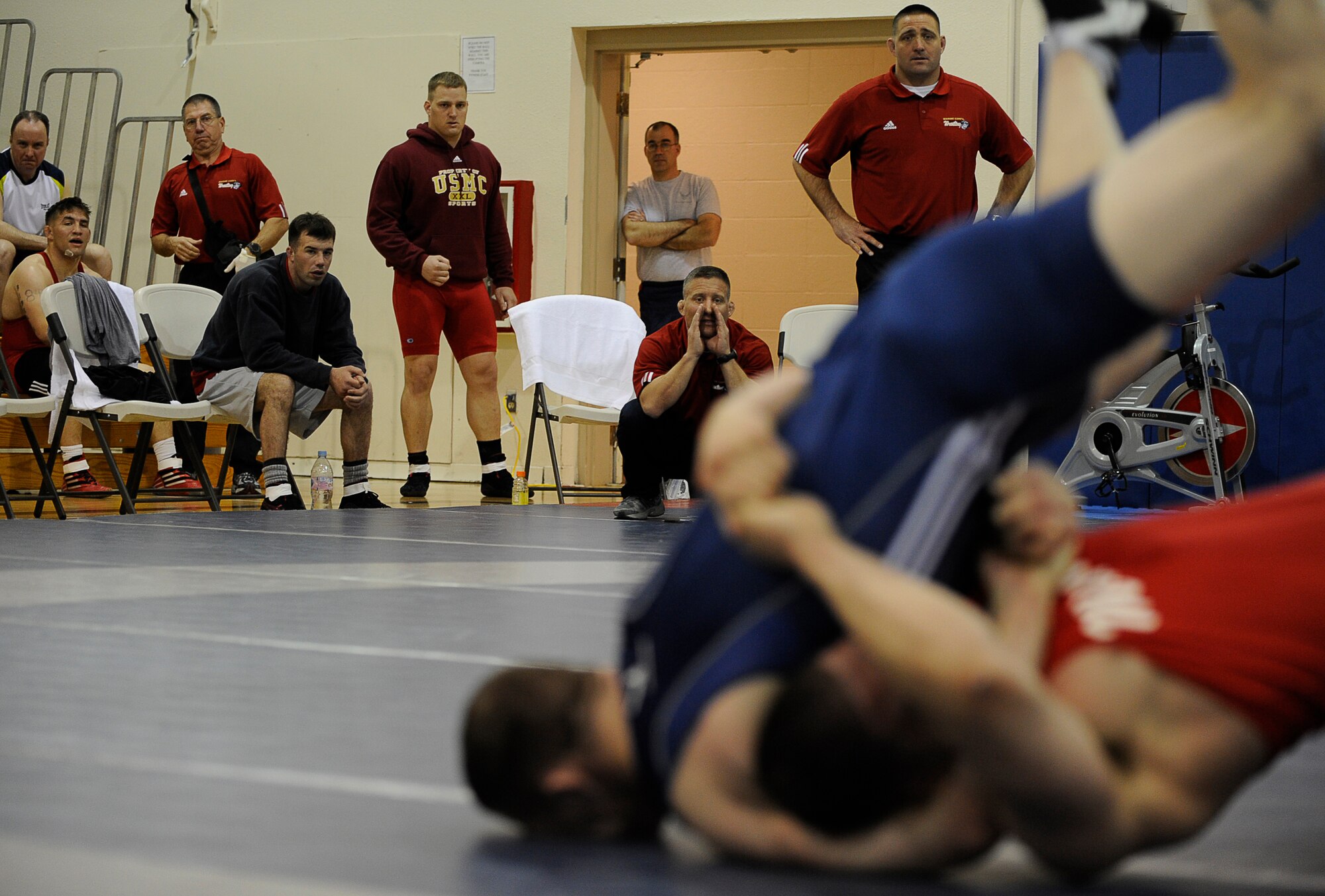 MOUNTAIN HOME AIR FORCE BASE, Idaho -- Members of the Marine wrestling team watch as one of their team members wrestles Greco-Roman style against an Air Force wrestler at the 2009 Armed Forces Wrestling Championships March 14 at Mountain Home Air Force Base. At the two-day Armed forces event that brought together all the best wrestlers across Department of Defense, the Army dominated the mats to win 12 of 14 gold medals. (U.S. Air Force photo/ Senior Airman Stephany Miller) 