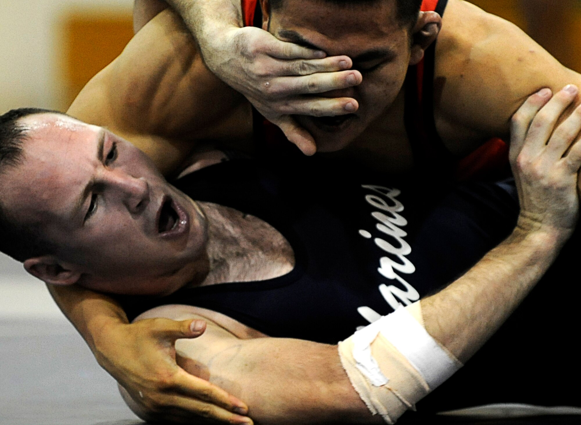MOUNTAIN HOME AIR FORCE BASE, Idaho -- A member of the Marine wrestling team wrestles a member of the Navy wrestling team at the 2009 Armed Forces Wrestling tournament March 15 at Mountain Home Air Force Base. At the two-day Armed forces event that brought together all the best wrestlers across Department of Defense, the Army dominated the mats to win 12 of 14 gold medals. (U.S. Air Force photo/ Senior Airman Stephany Miller)