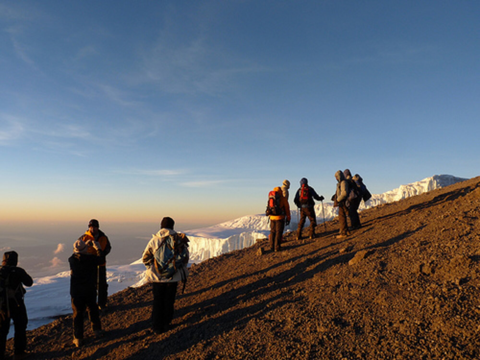 As they climb Mount Kilimanjaro in Tanzania, a group of hikers including Mike Domstead of the JAC pause to view a 400 foot high glacier.  (Photo courtesy of Mike Domstead).