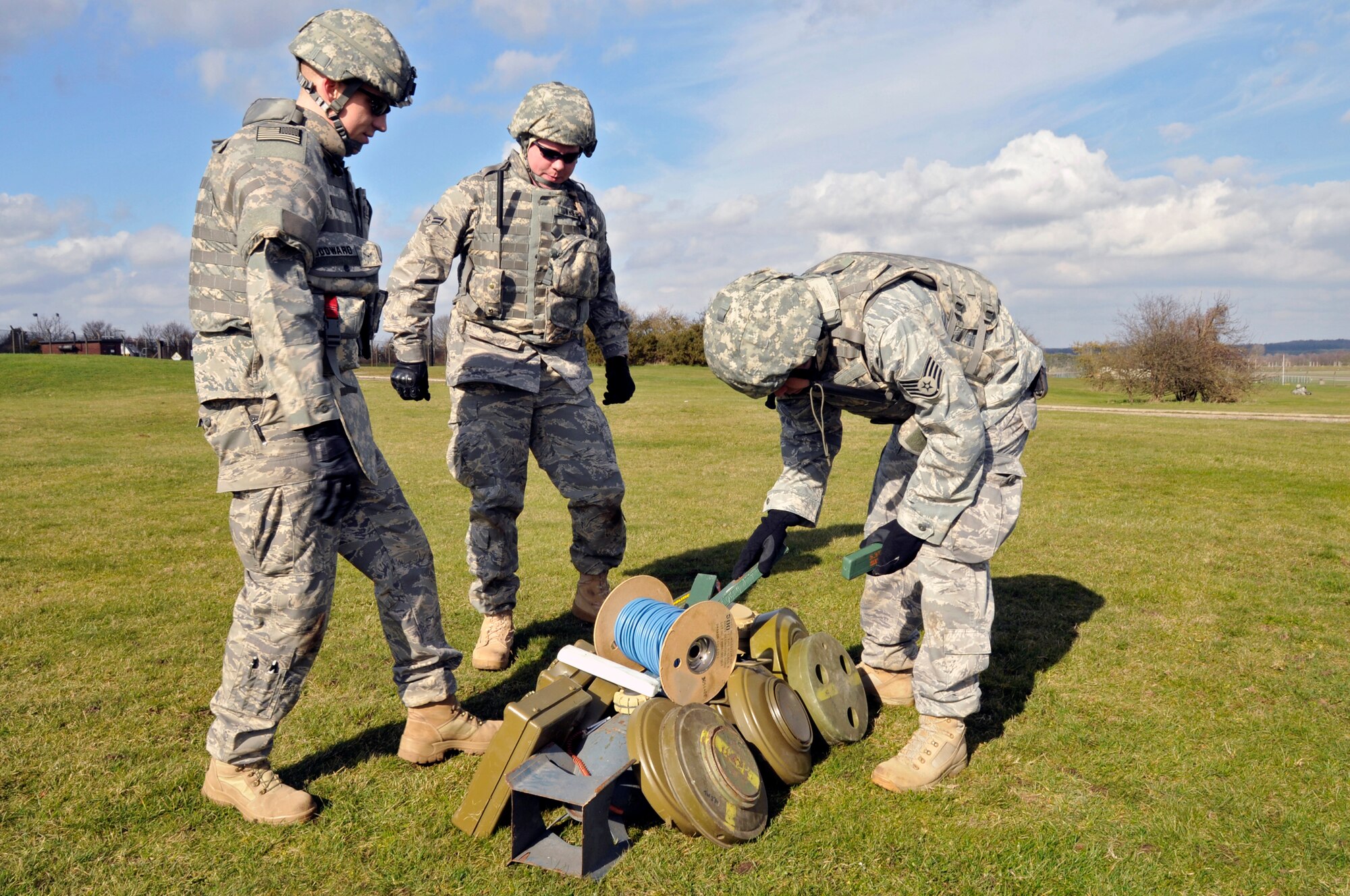 Staff Sgt. Casey Pascoe shows Airman 1st Class Rileigh Woodward, Airman 1st Class Christopher Townsend, 48th Civil Engineer Squadron explosive ordnance disposal team members, the best way to arrange the plastic explosive so it will destroy all of the weapons March 6, 2009 at RAF Lakenheath, England. EOD Airmen participated in a ground assault exercise that will prepair Airman for future deployments and tie into the units physical training program. (U.S. Air Force photo by Airman 1st Class Perry Aston) (Released)