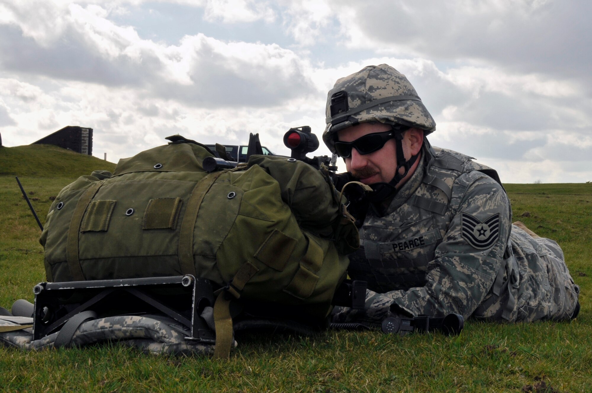 Tech Sgt. Christopher Pearce, 48th Civil Engineer Squadron explosive ordnance disposal team member, guards the perimeter March 6, 2009 at RAF Lakenheath, England. EOD Airmen not directly involved in disposing of enemy weapons set up a defensive perimeter around the simulated enemy weapons cache. (U.S. Air Force photo by Airman 1st Class Perry Aston)