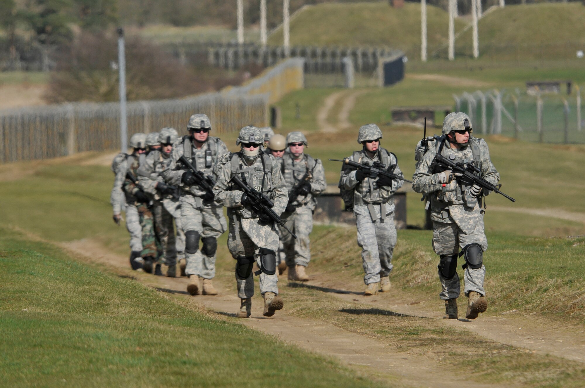 48th Civil Engineer Squadron explosive ordnance disposal team, march alongside the base perimeter on the flightline March 6, 2009 at RAF Lakenheath, England. EOD Airmen marched around the RAF Lakenheath perimeter as part of a ground assault exercise, and their physical training program. (U.S. Air Force photo by Airman 1st Class Perry Aston)