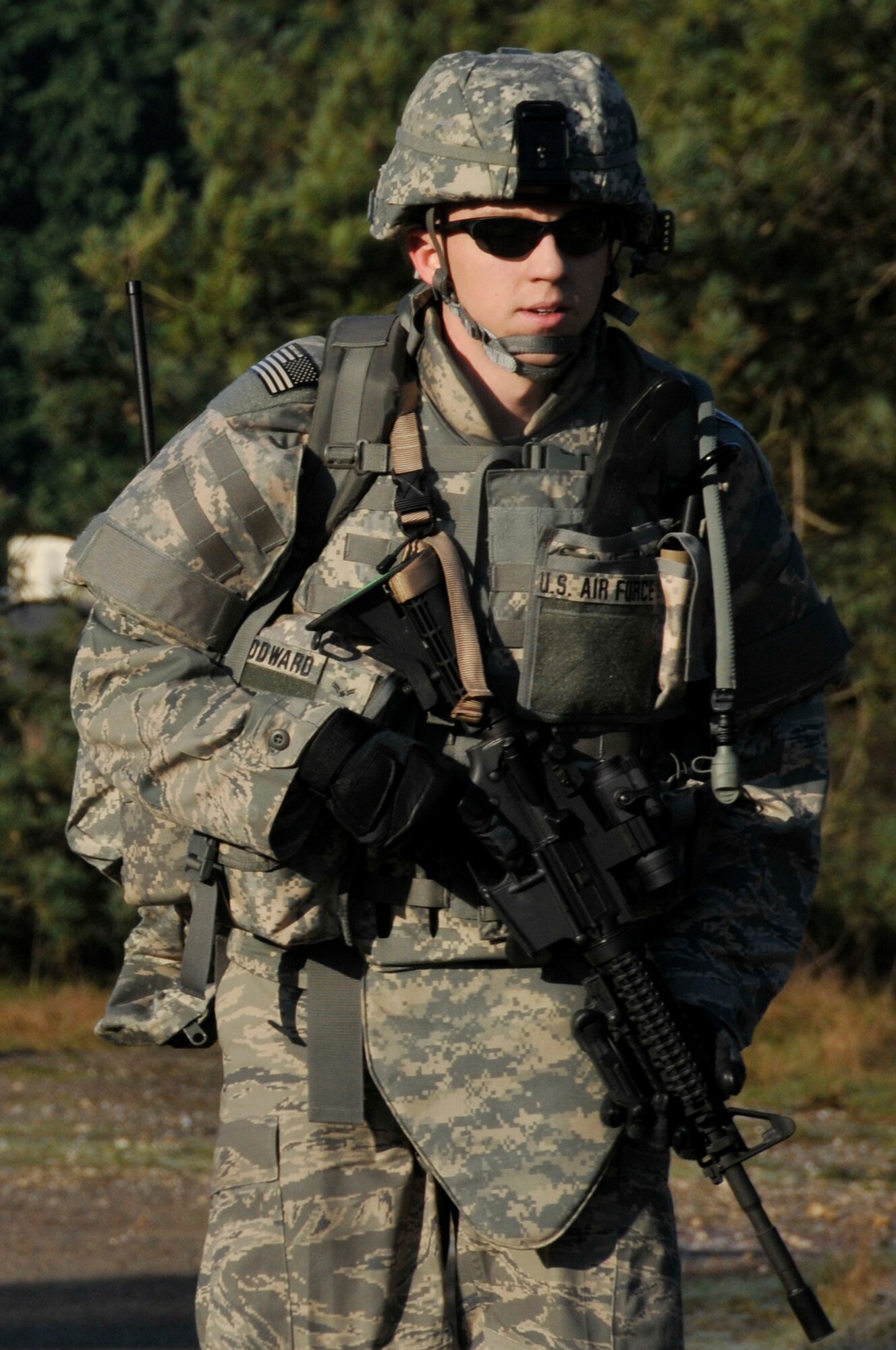 Airman 1st Class Rileigh Woodward, 48th Civil Engineer Squadron, explosive ordnance disposal team member marches down perimeter road on alert for any enemy movement March 6, 2009 at RAF Lakenheath, England. EOD Airmen march around the base perimeter twice a month as a part of the unit's physical training program  (U.S. Air Force photo by Airman 1st Class Perry Aston)