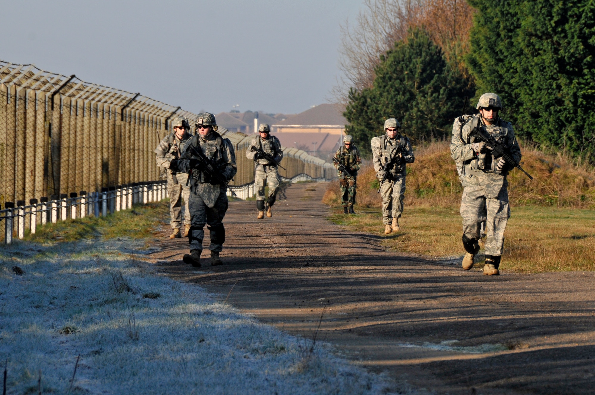 48th Civil Engineer Squadron, explosive ordnance disposal team march down perimeter road to the first simulated weapons cache they will have to destroy March 6, 2009 at RAF Lakenheath, England. EOD Airmen marched around the RAF Lakenheath perimeter and searched for three simulated enemy weapons caches. (U.S. Air Force photo by Airman 1st Class Perry Aston)